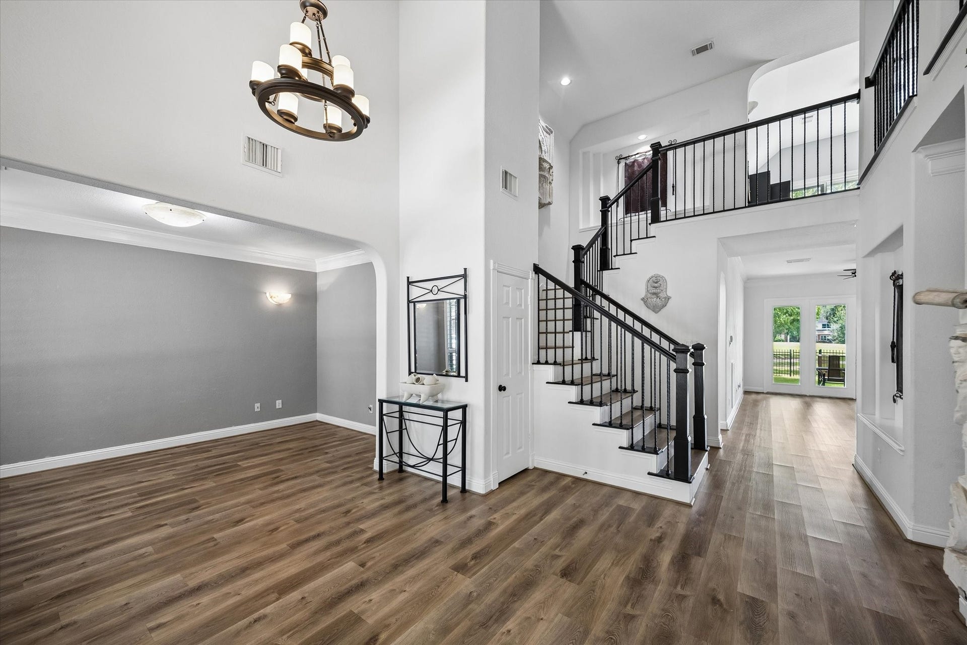 A dramatic staircase creates a stunning first impression, featuring beautifully updated balusters and handrails that enhance the home's timeless elegance.