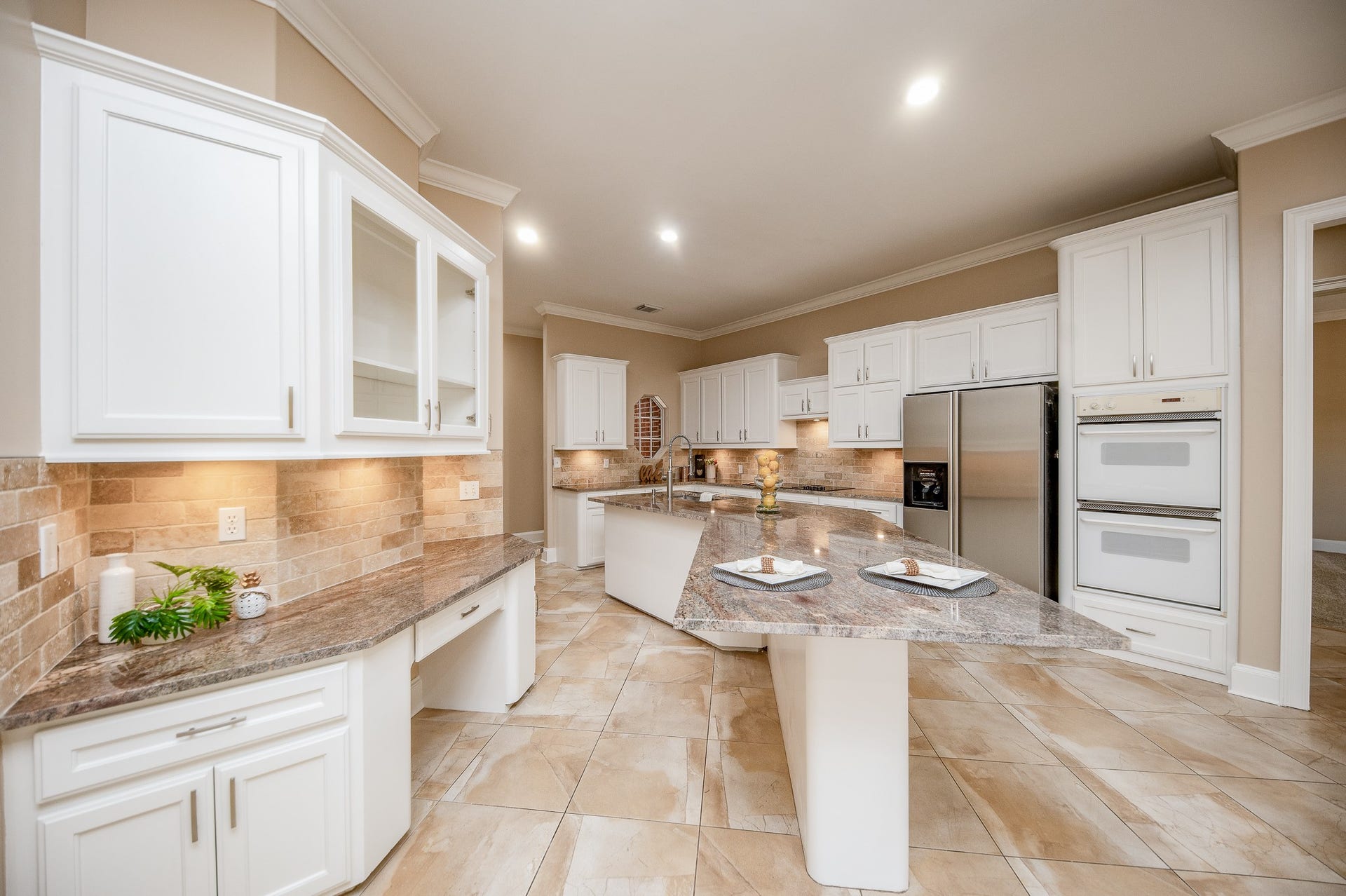 23014 Laguna Point Drive, Katy, TX 77450 There's just something about a primarily white kitchen that warms and invites us, in any genre or style! Here, we have a streamlined version of such, with lots of cabinetry, new earth toned granite counters and room, galore!
