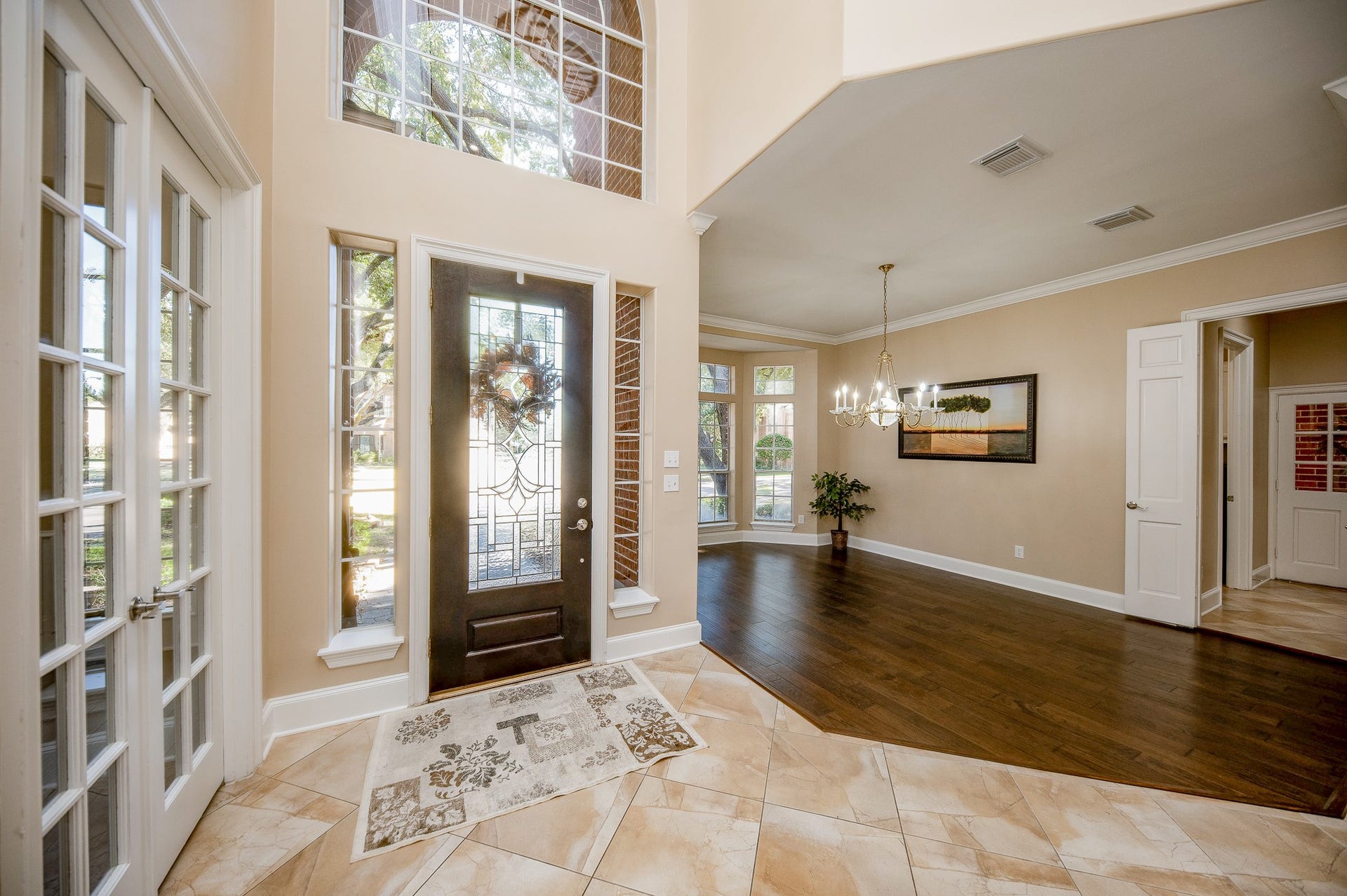 23014 Laguna Point Drive, Katy, TX 77450 Here's a closer view of the amazing front space offered in the home. At left, behind lovely classic french doors, is a perfect spot for a private home office/study; while the sprawling generous space (right) constitutes a picturesque formal dining area, with new wood flooring.