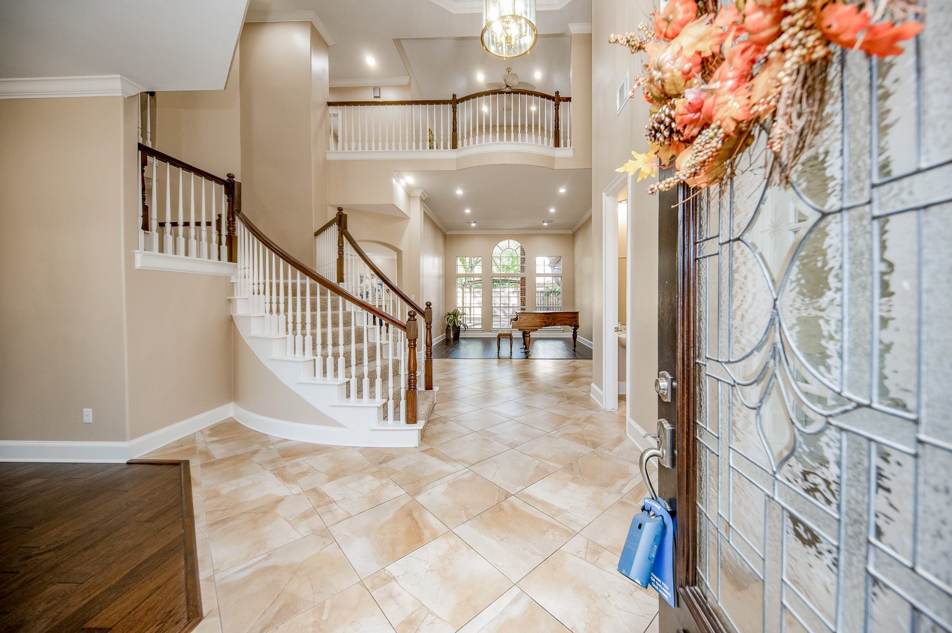 23014 Laguna Point Drive, Katy, TX 77450 The stunning etched glass front door opens onto your first amazing view of the 1st floor entry/main hallway and foyer, featuring its striking carpeted spiral staircase, up to the grand 2nd level balconies overlooking the elegant 1st level entry. Bright, light and amazing!