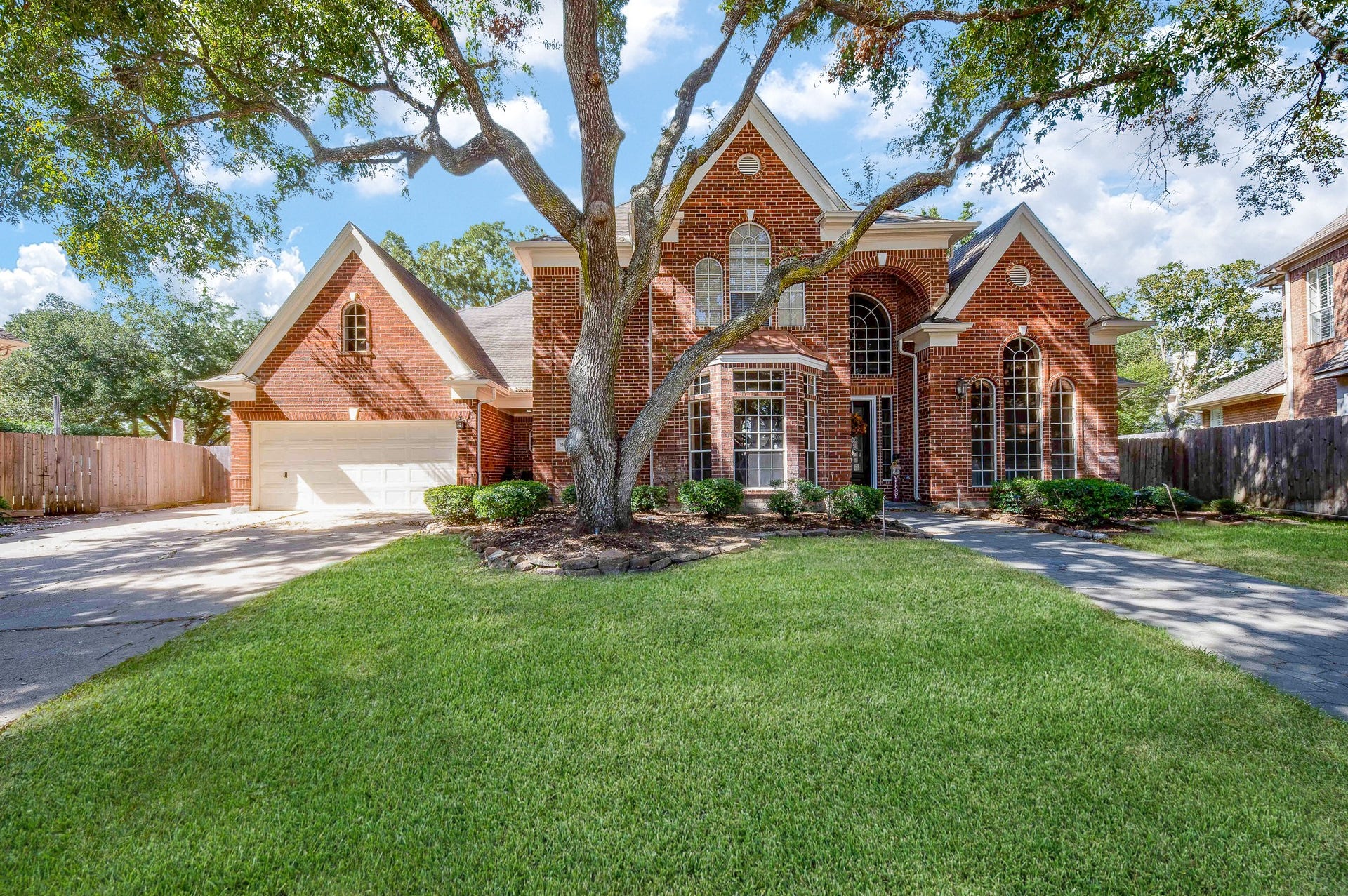 23014 Laguna Point Drive, Katy, TX 77450 Lush, native greenery embraces this exquisite single family, 2-story, brick beauty at 23014 Laguna Point Drive, Katy, TX, in the South Lake gated community.