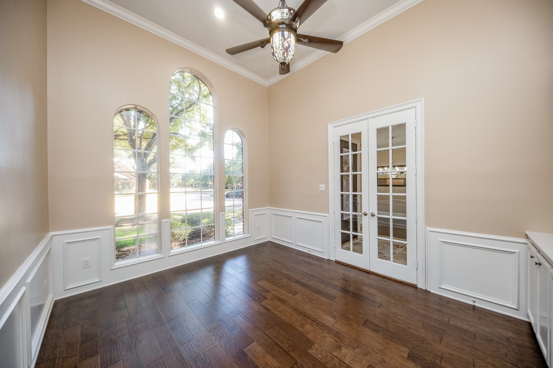 23014 Laguna Point Drive, Katy, TX 77450 A gorgeous high ceiling embraces triple arched windows, wood floors and tremendous space in this lovely front room, with pure natural light, and private french doors.