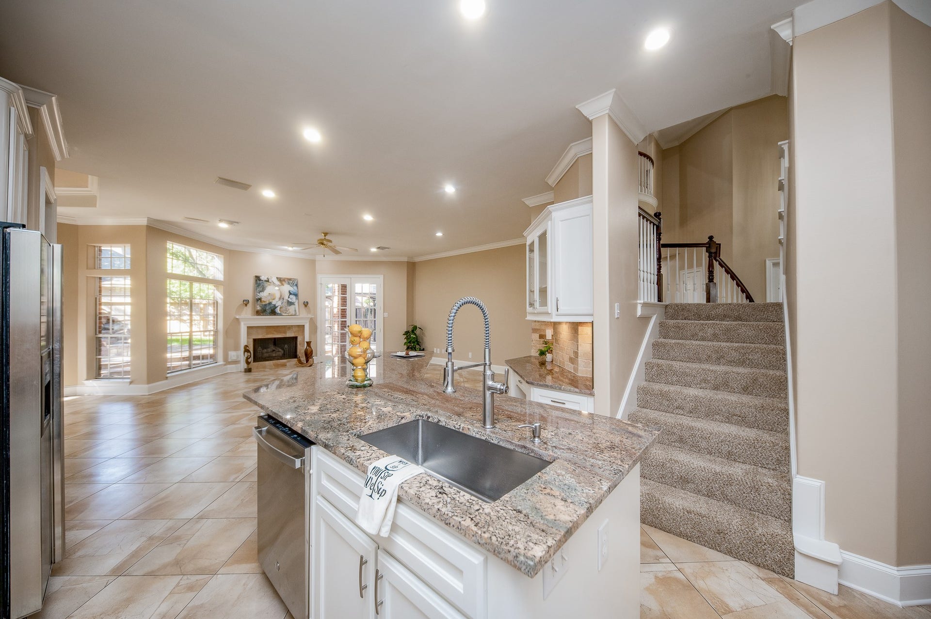 23014 Laguna Point Drive, Katy, TX 77450 This marvelous kitchen area is bound to become 'family central', open to common living spaces, with a slip of carpeted stairs descending directly into this wide open area.