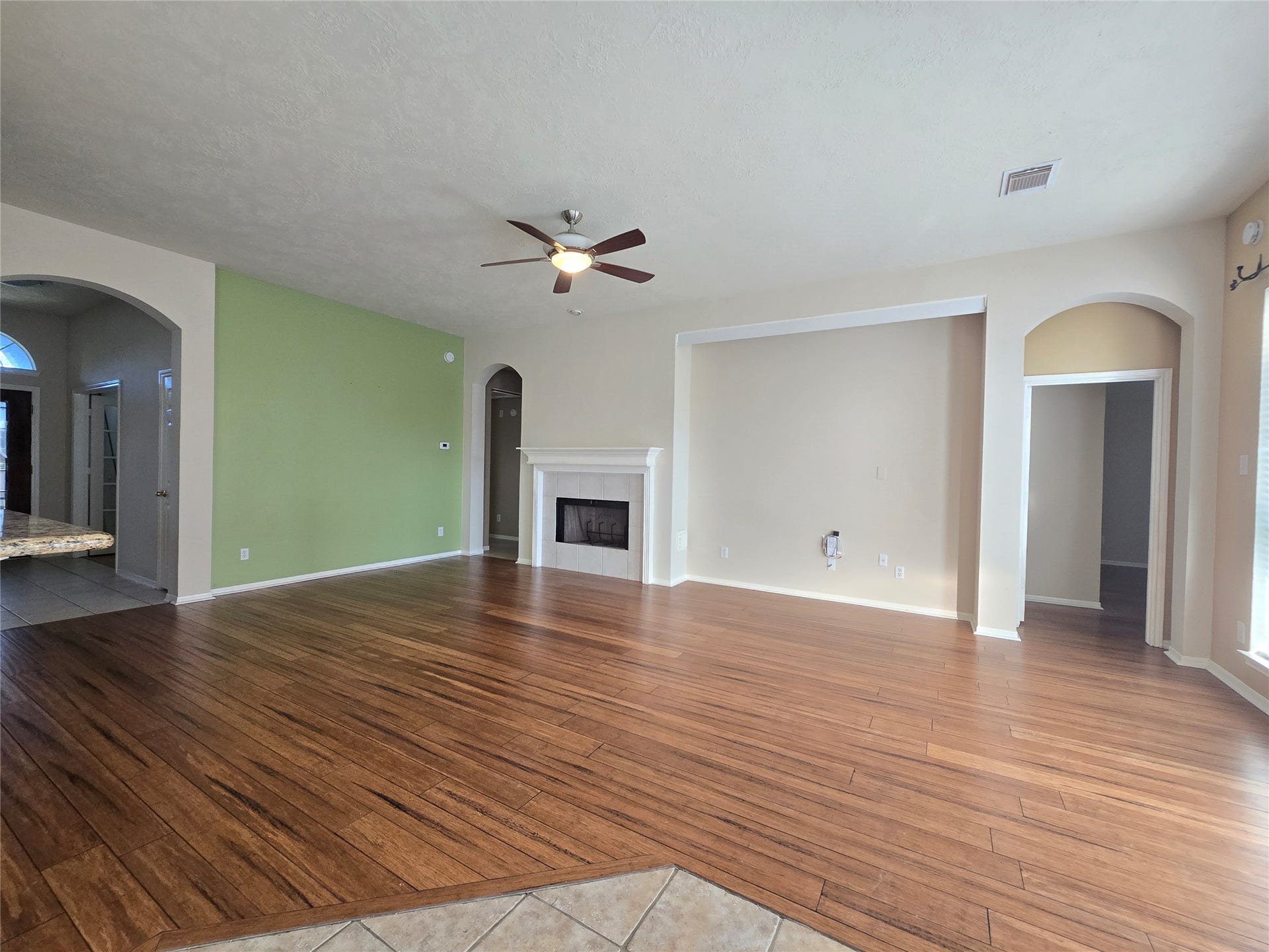 Large living room with entertainment niche and gas fireplace