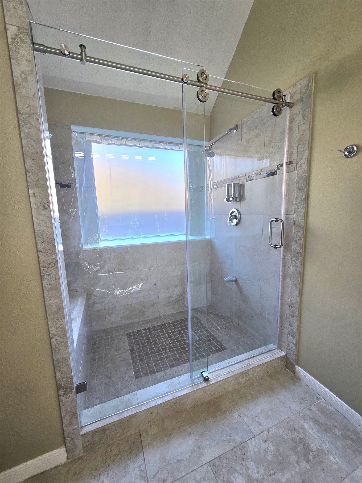 Large updated shower with a sliding glass door