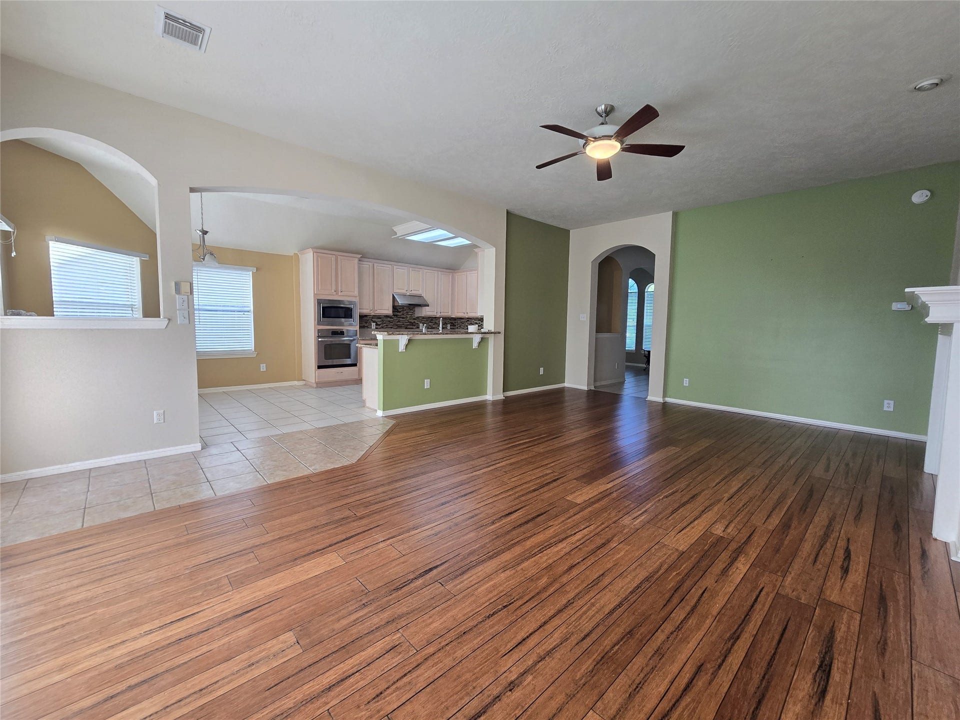 Large archway opens to the kitchen and breakfast area