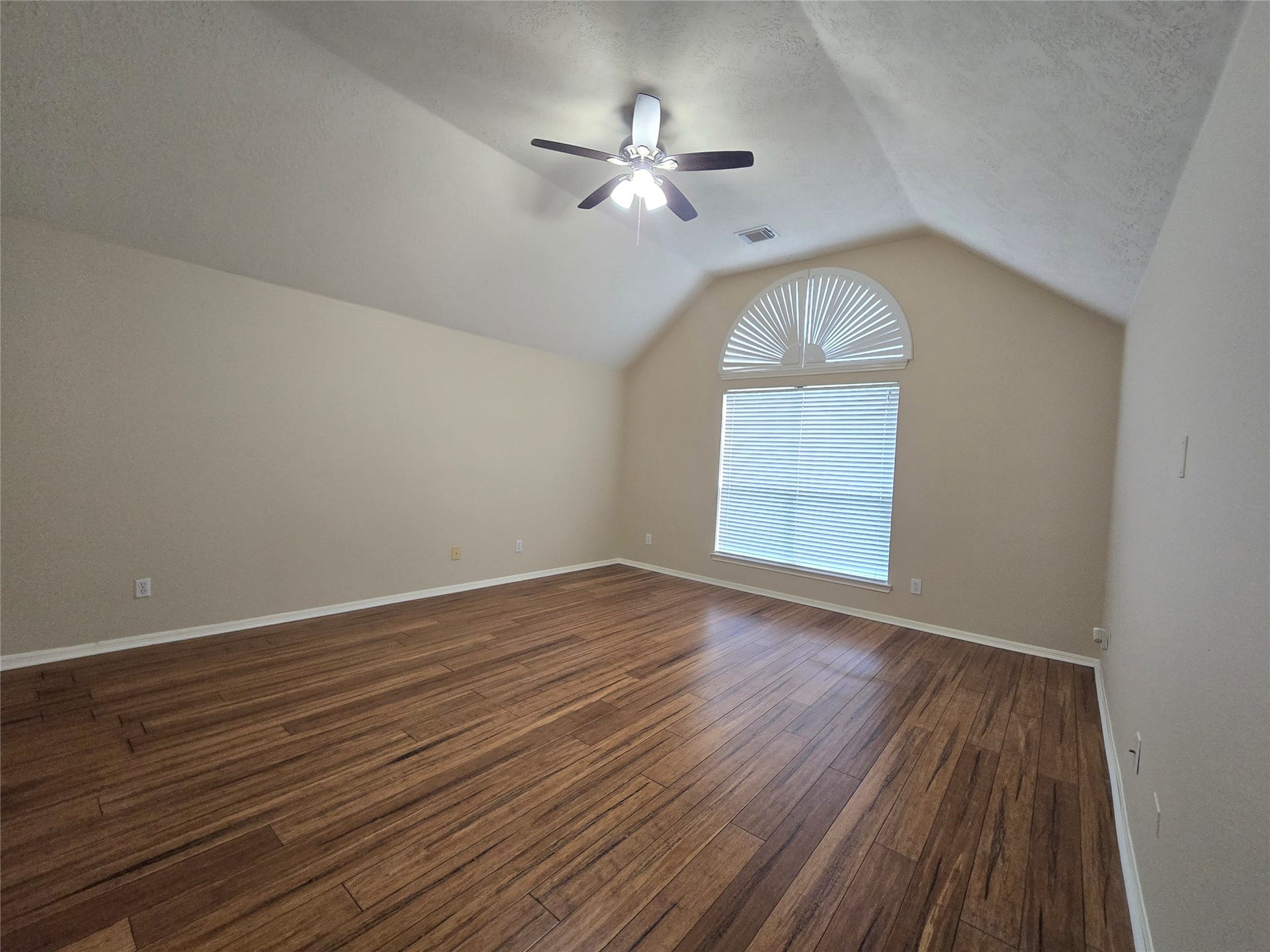 Primary Bedroom with high vaulted ceiling