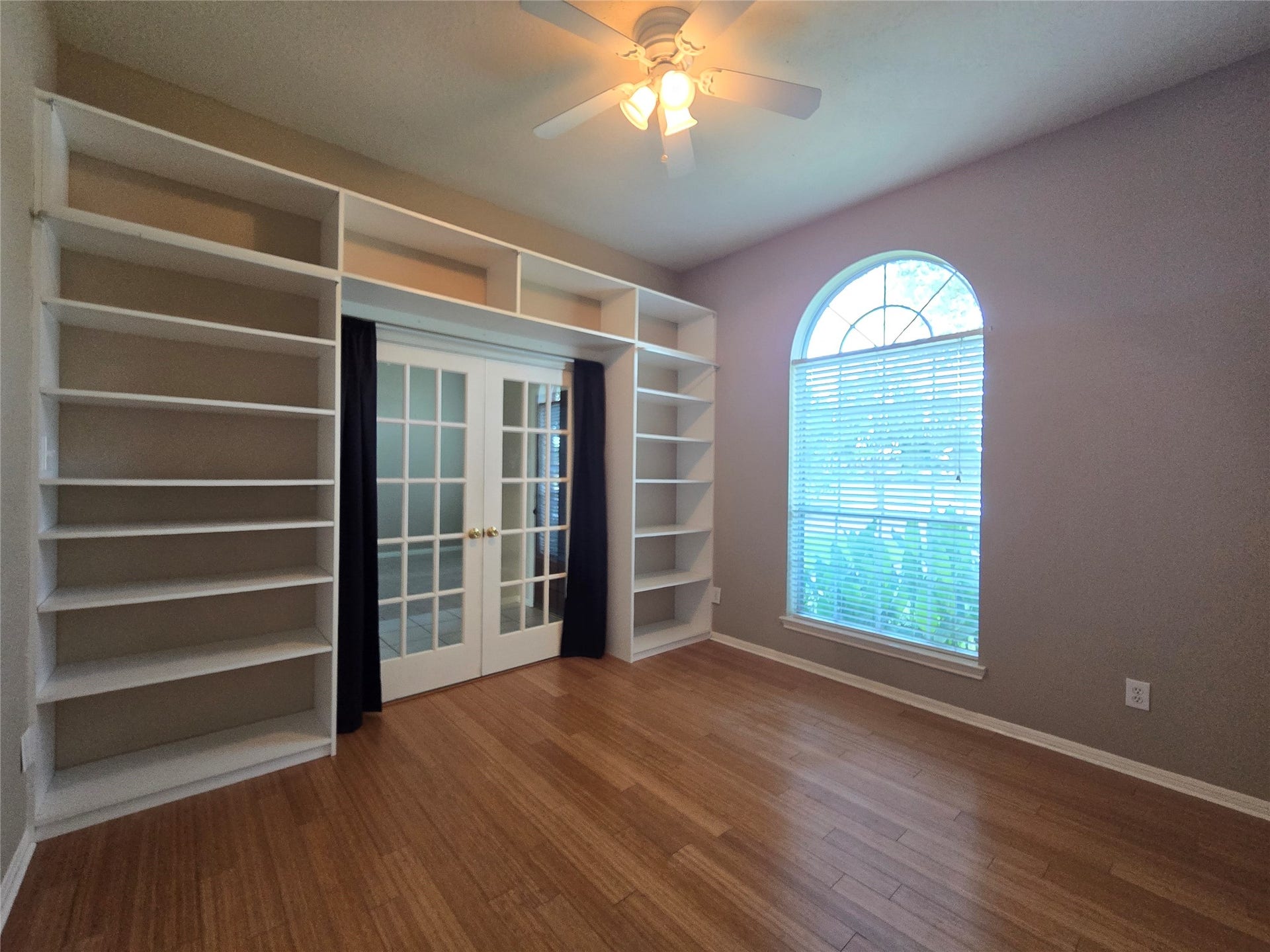 Home Office/Study with built-in custom shelving for ample storage.