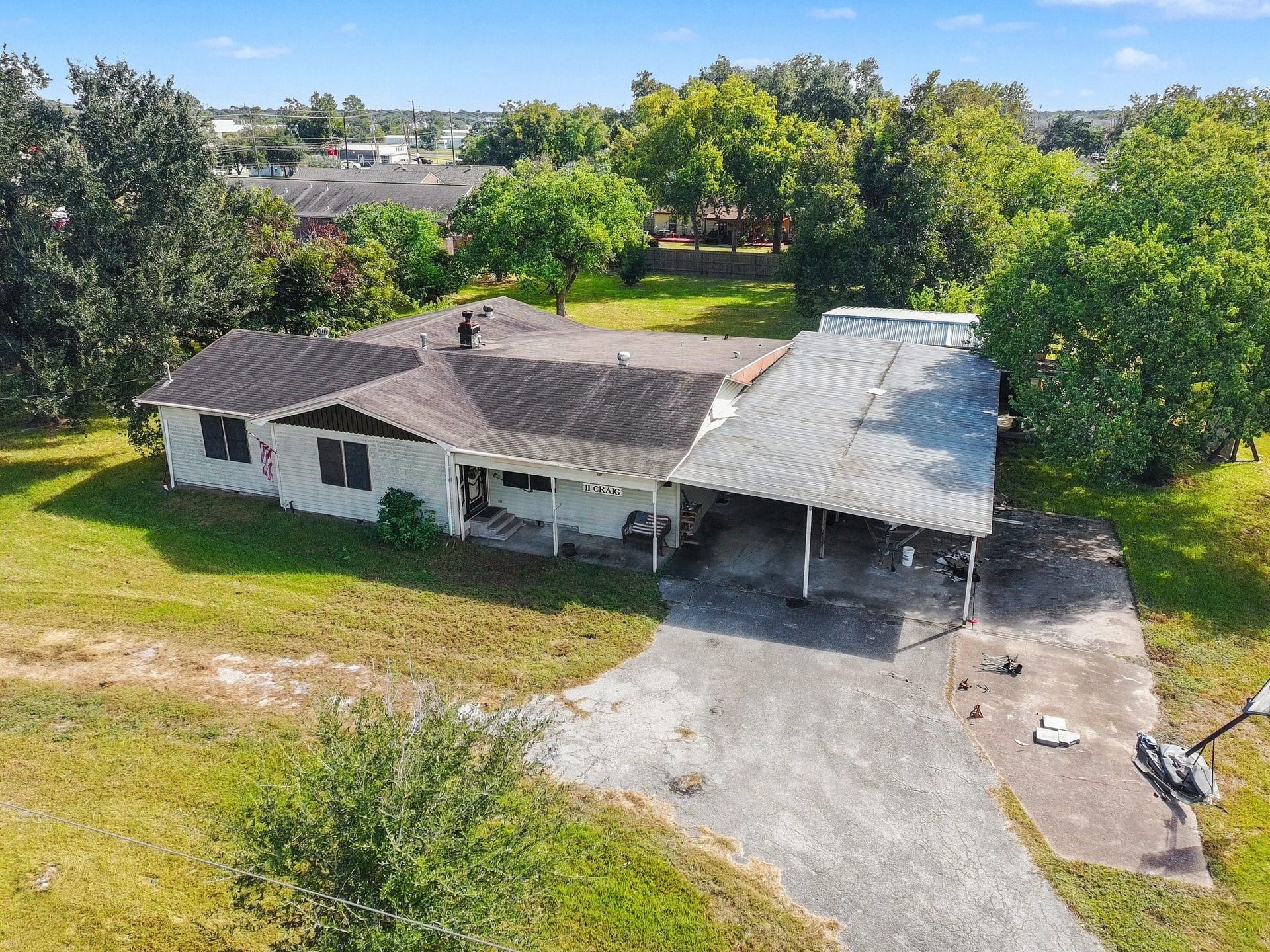 11 Craig Street, Baytown, TX 77521 Fixer-Upper on approximately 1.07 acres with mature trees, covered parking, and plenty of potential