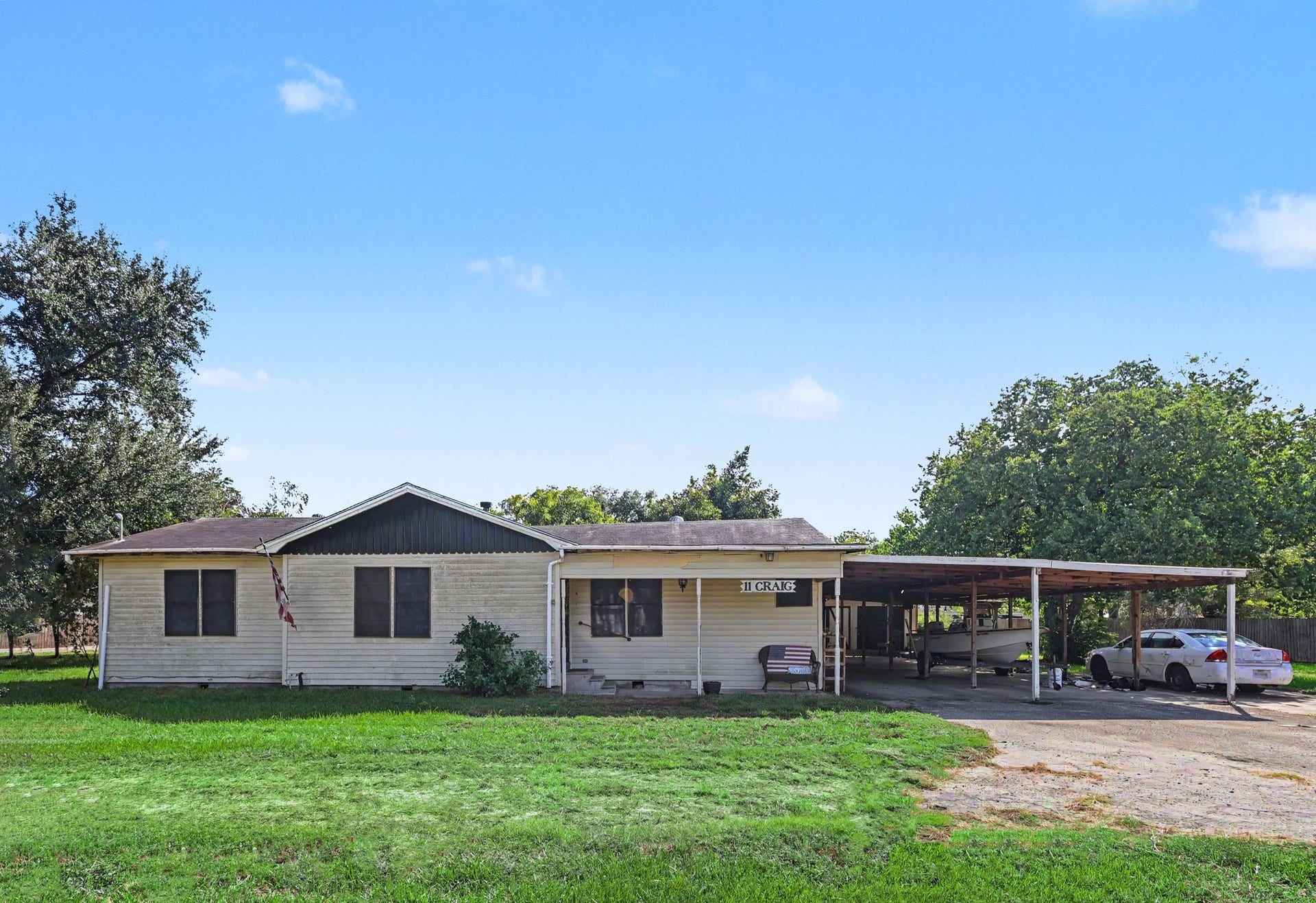 11 Craig Street, Baytown, TX 77521 Front view featuring a covered porch, spacious carport and large front yard