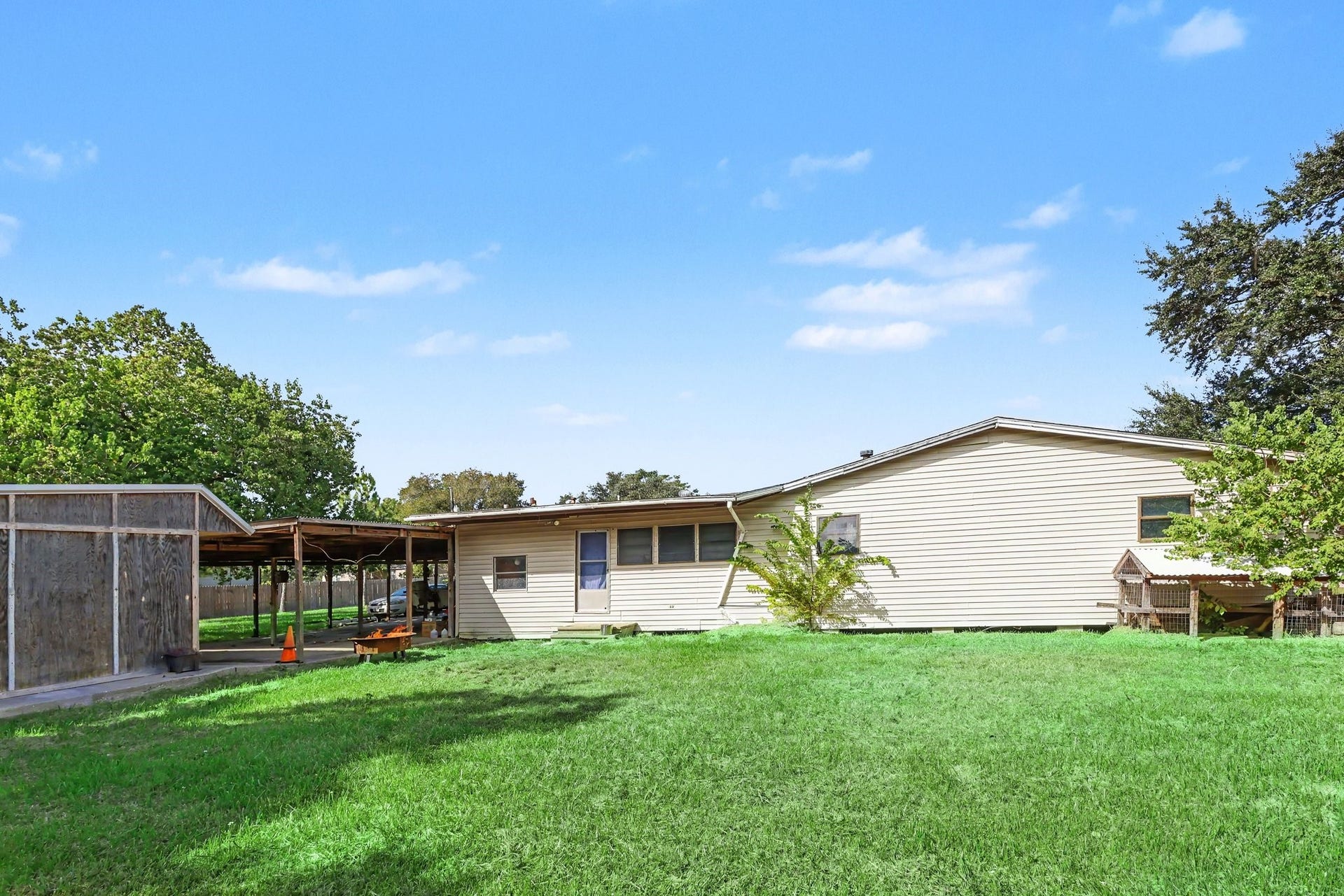 11 Craig Street, Baytown, TX 77521 Spacious backyard with mature trees, a covered patio and ample room for outdoor activities