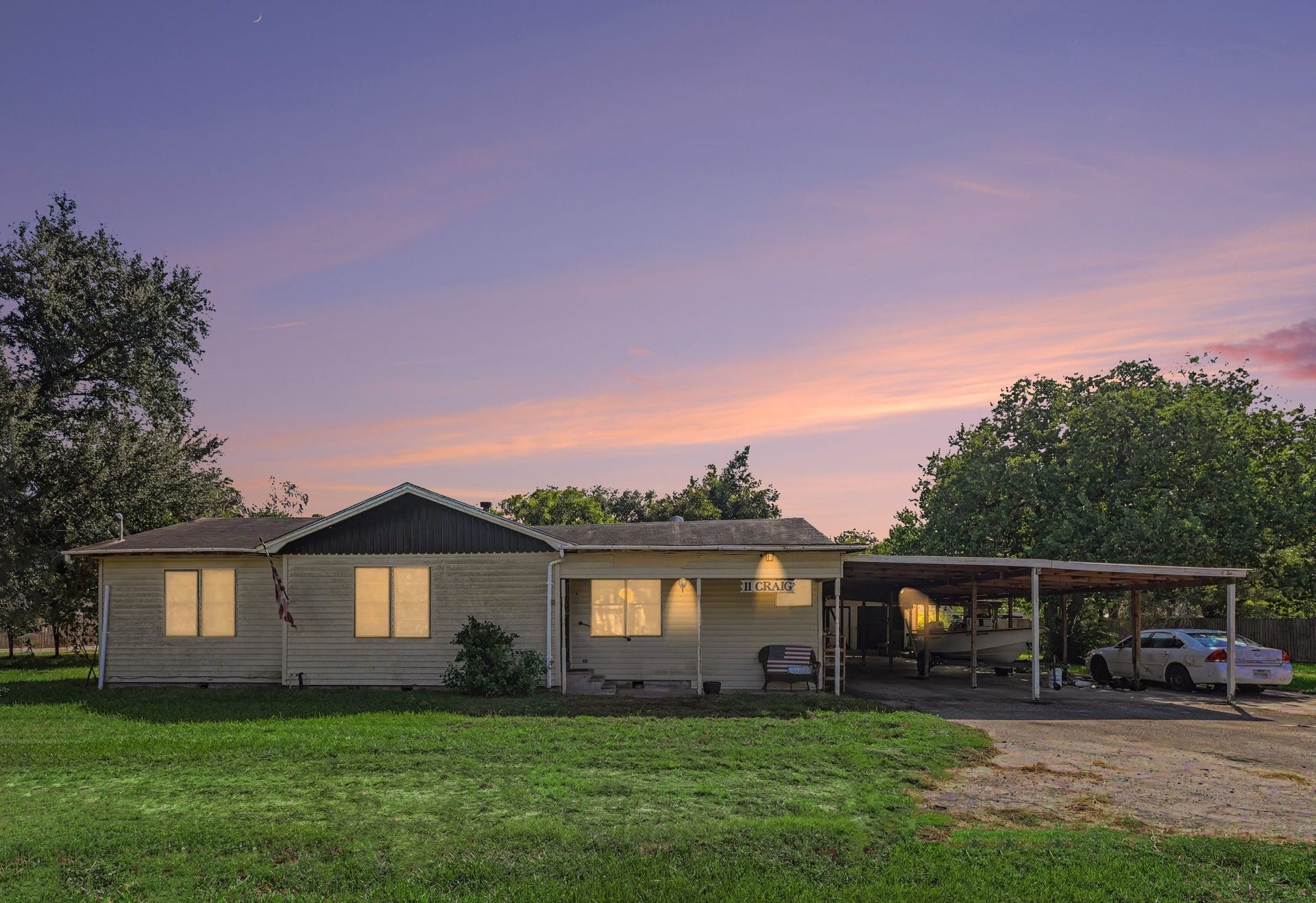 11 Craig Street, Baytown, TX 77521 Front exterior photo enhanced with AI to simulate twilight and lighting