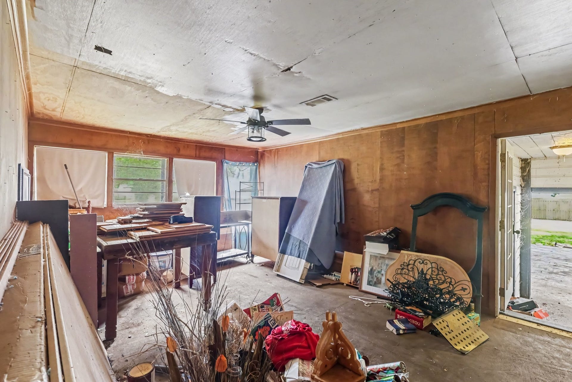 11 Craig Street, Baytown, TX 77521 Family Room with wood paneling and outdoor access.