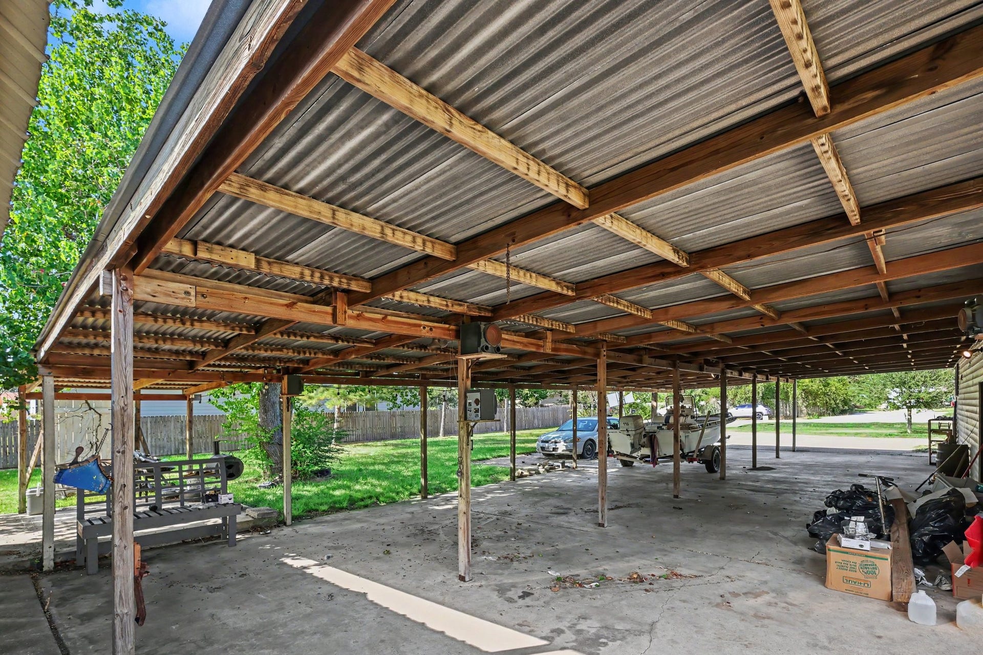 11 Craig Street, Baytown, TX 77521 Expansive covered patio and carport with a concrete surface and ample space for parking