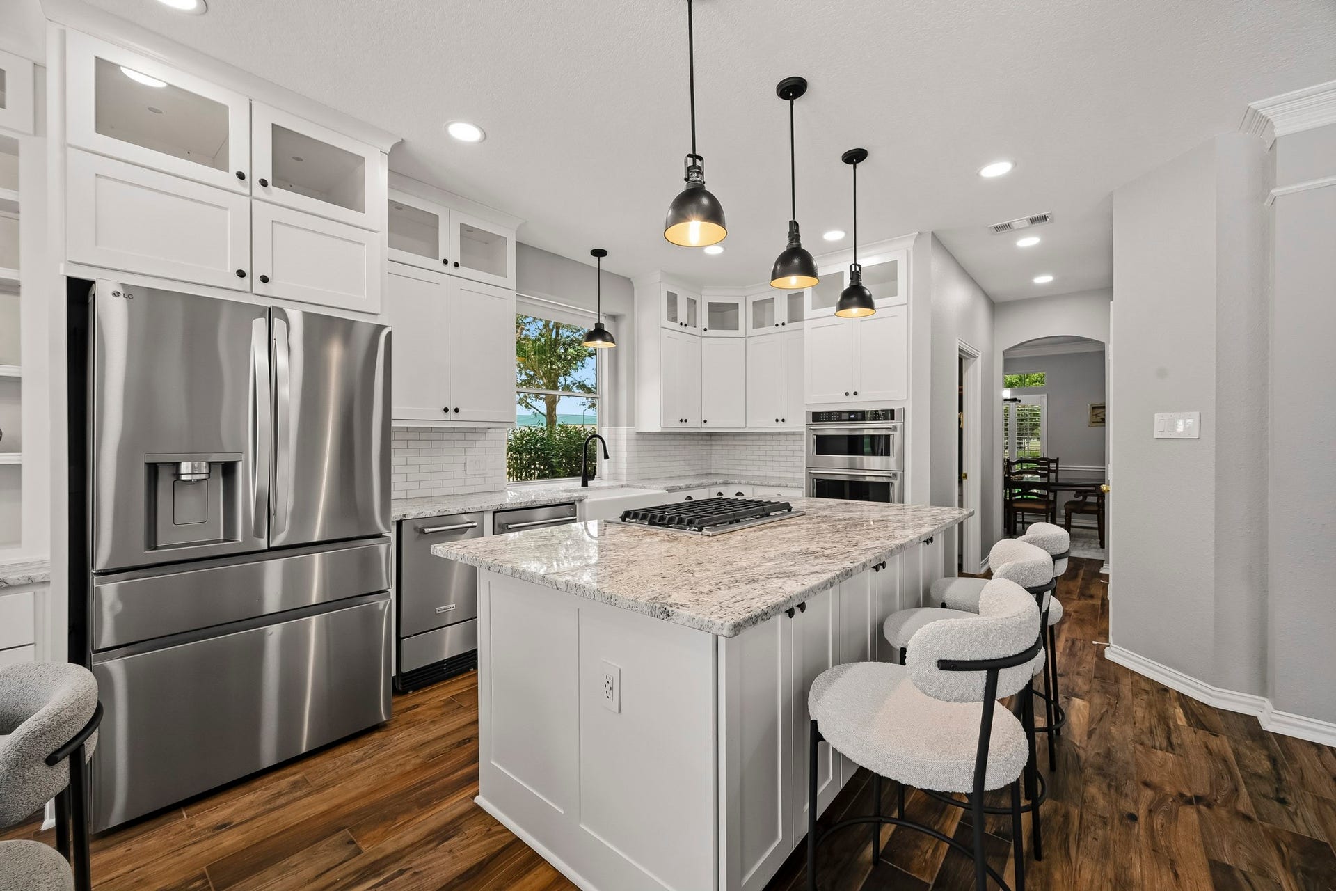 5702 Misty Island Court, Katy, TX 77494 Modern kitchen with sleek stainless steel appliances, a spacious granite island, and stylish pendant lighting, perfect for entertaining.