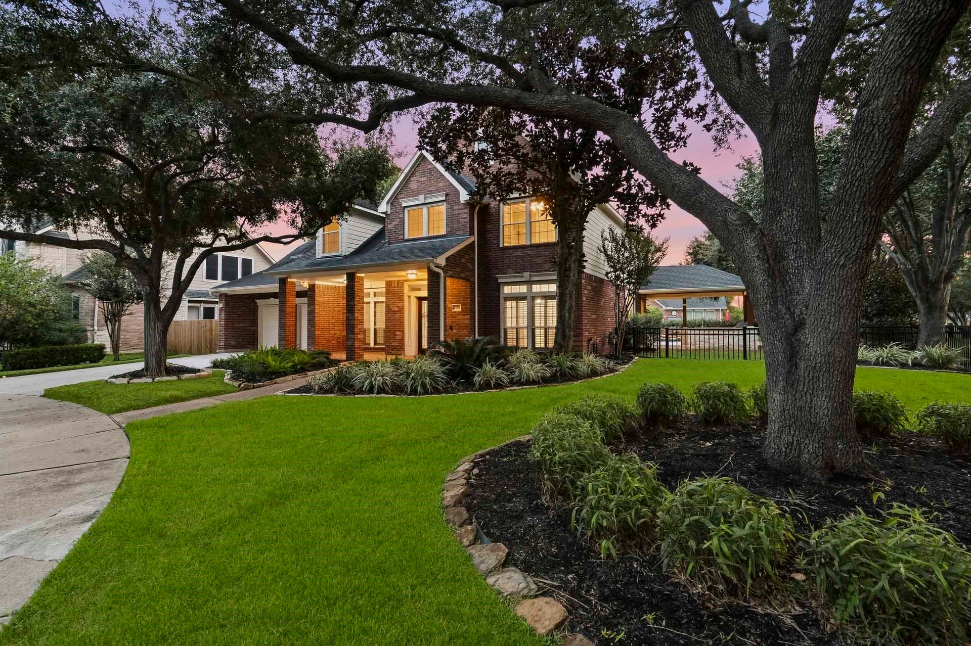 5702 Misty Island Court, Katy, TX 77494 Bright and inviting kitchen with modern pendant lighting, a spacious marble island with seating, sleek stainless steel appliances, and a view of the backyard pool through large windows.