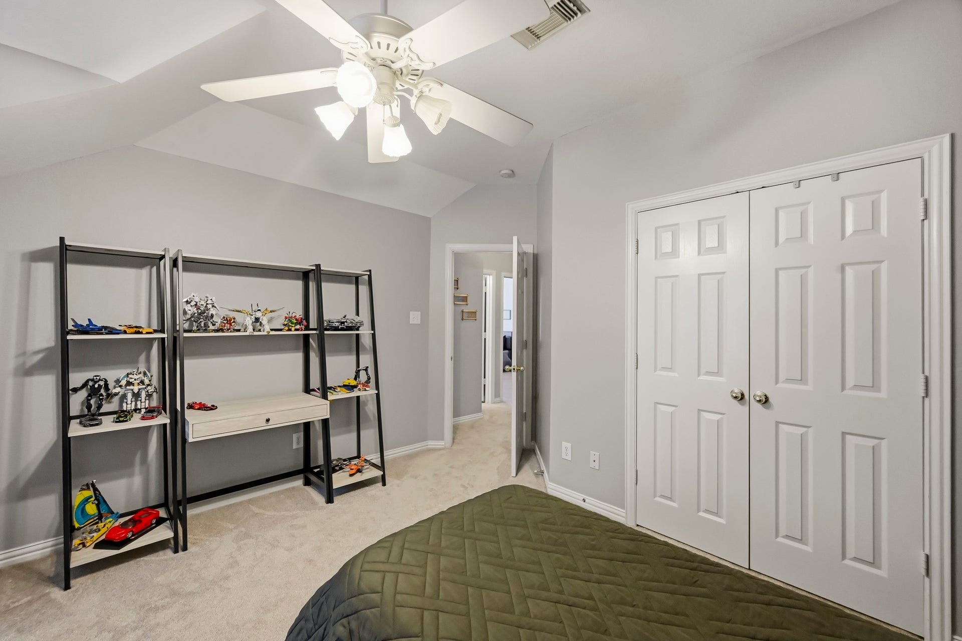 5702 Misty Island Court, Katy, TX 77494 Bright and spacious bedroom featuring a ceiling fan, dual closets, and ample shelving for storage or display.