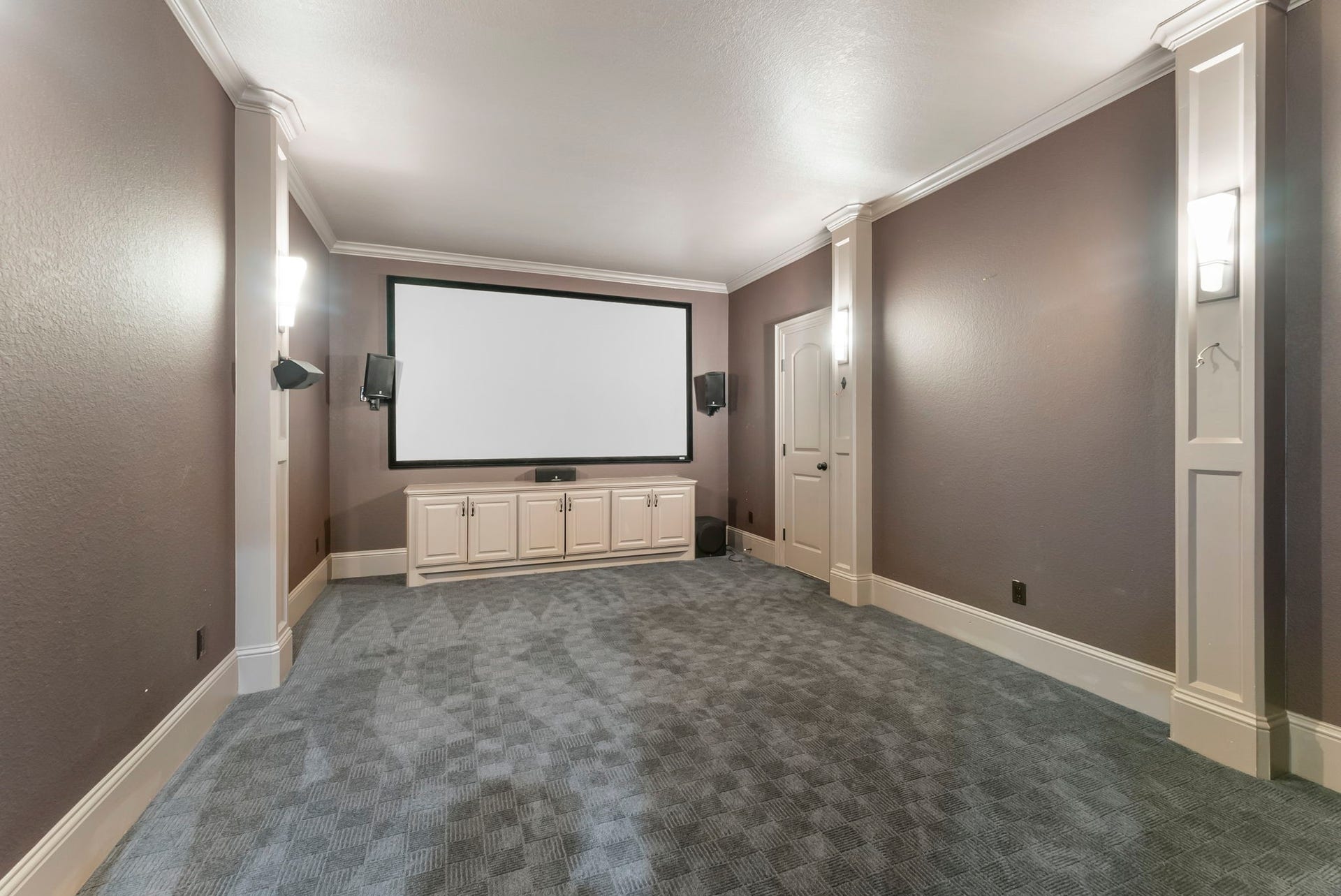 27507 Hunter Creek Court, Spring, TX 77386 Dedicated media room with projector screen, built-in cabinetry and theater-style layout.