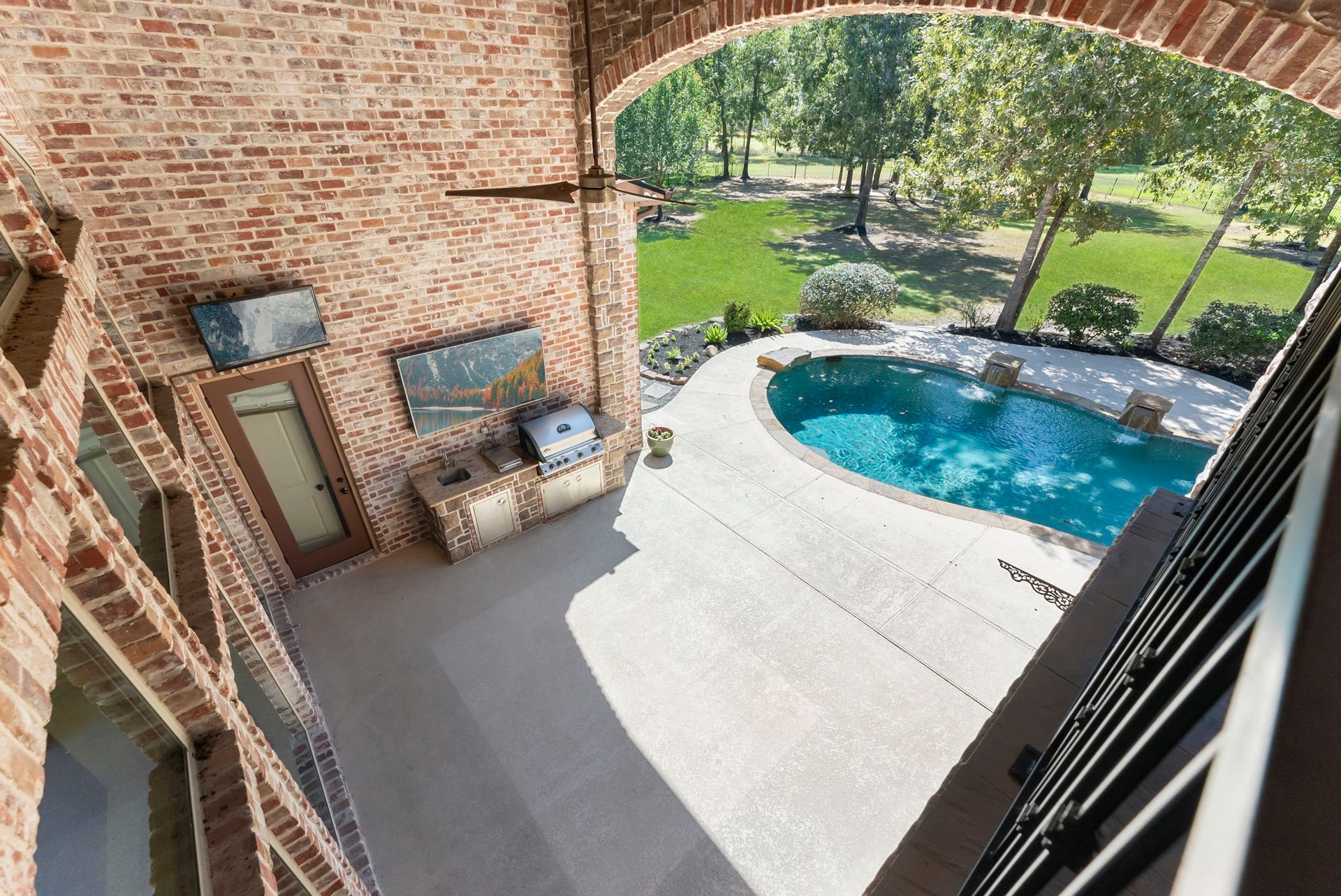 27507 Hunter Creek Court, Spring, TX 77386 Elevated balcony view overlooking the swimming pool, patio and wooded backyard.