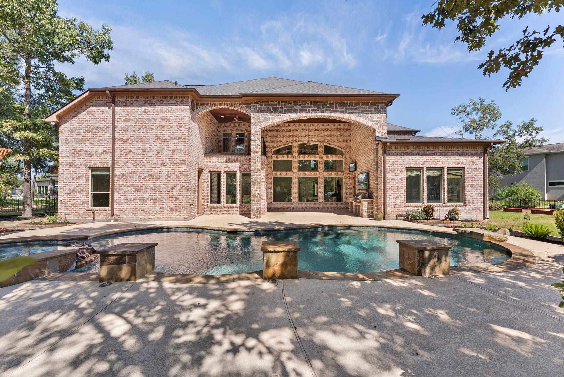 27507 Hunter Creek Court, Spring, TX 77386 Rear elevation overlooking the swimming pool and expansive outdoor living area.