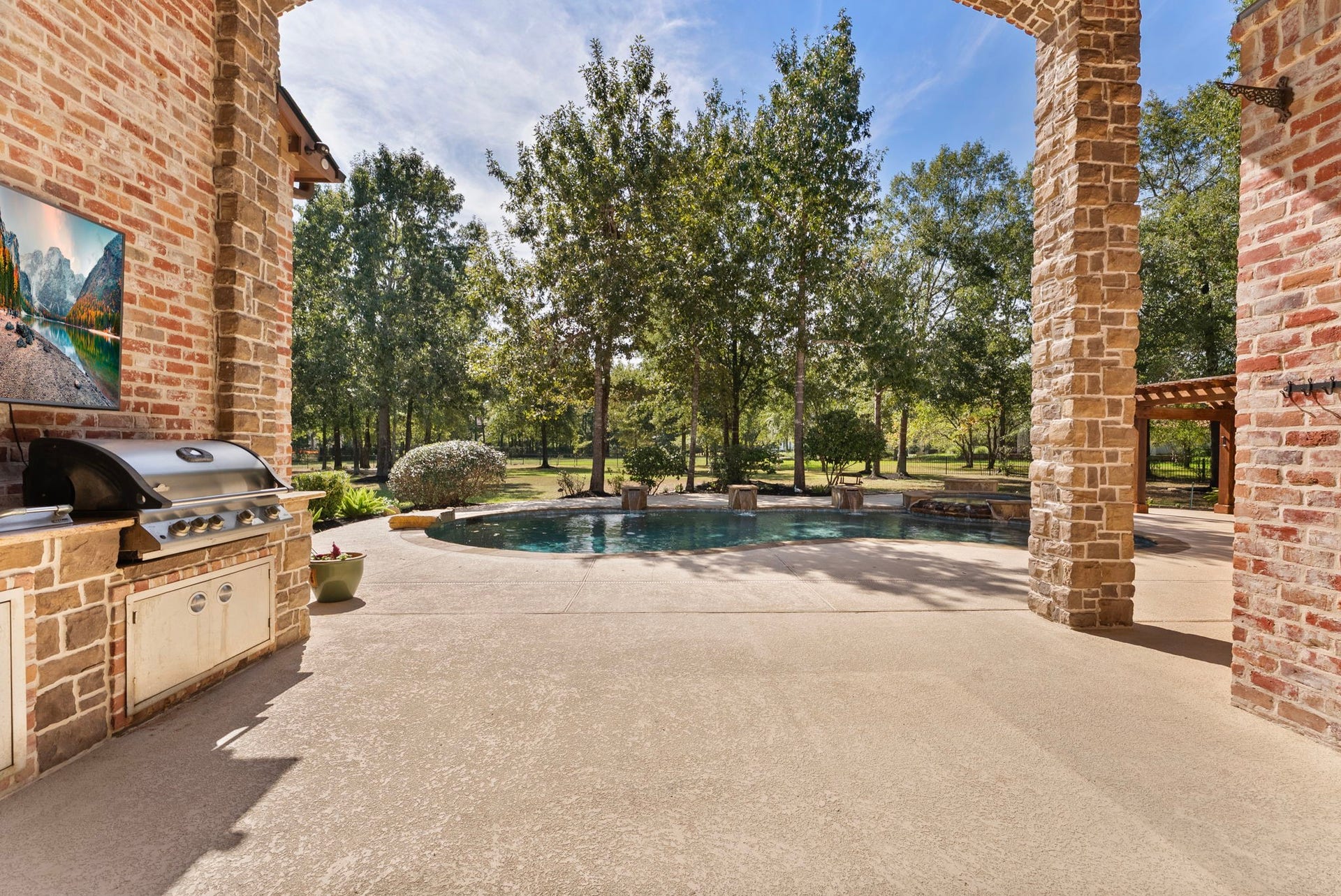 27507 Hunter Creek Court, Spring, TX 77386 Covered patio opening directly to the pool and landscaped backyard.