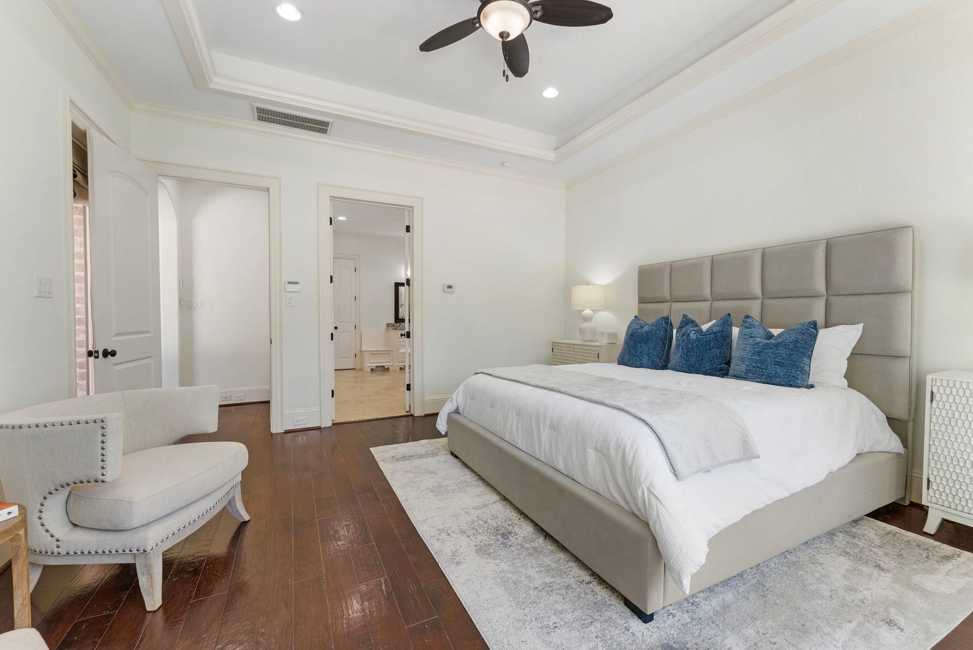 27507 Hunter Creek Court, Spring, TX 77386 Additional view of the primary bedroom showing the tray ceiling, hardwood flooring and bath entrance.