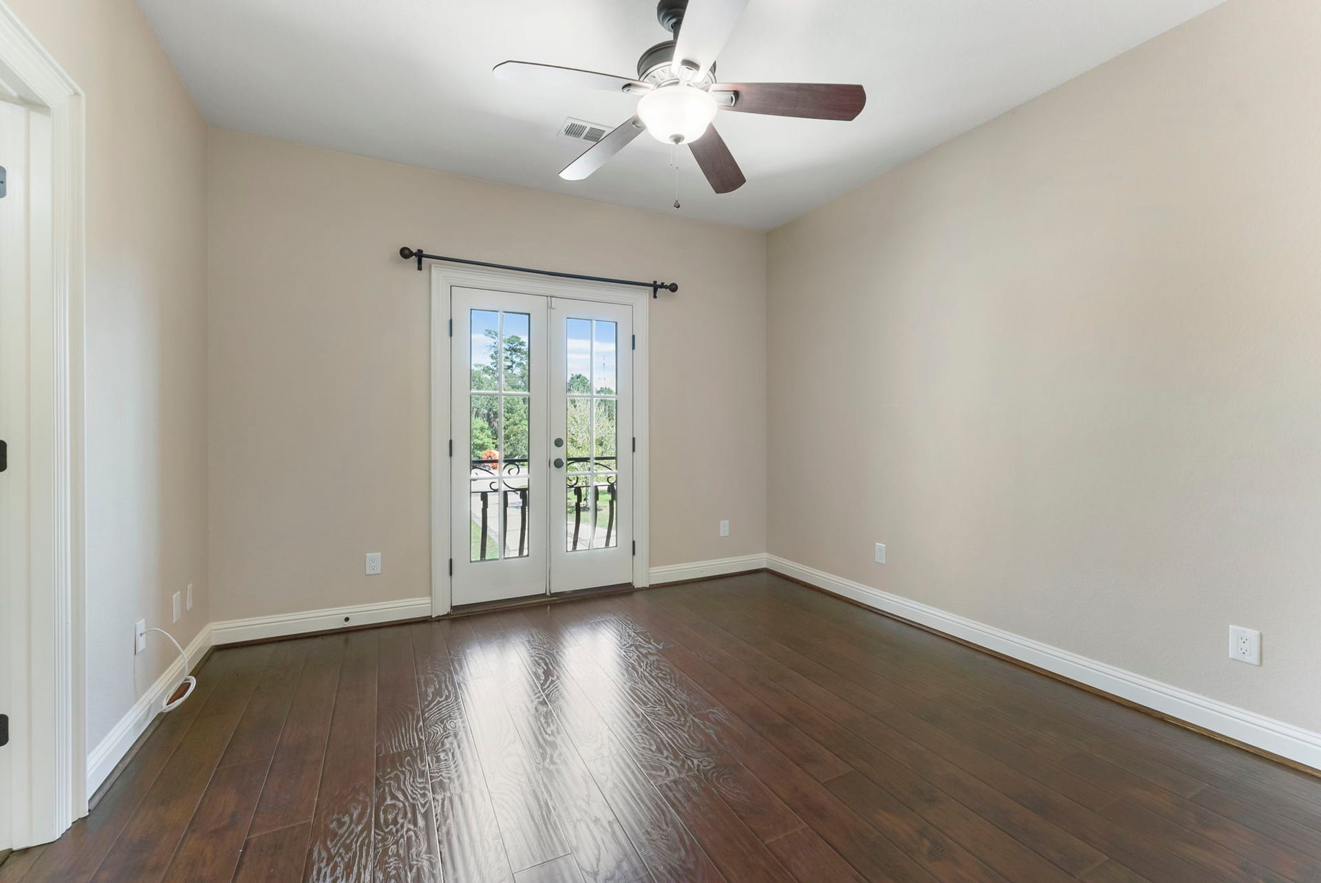 27507 Hunter Creek Court, Spring, TX 77386 Secondary room with hardwood flooring, ceiling fan and French doors leading to the balcony.