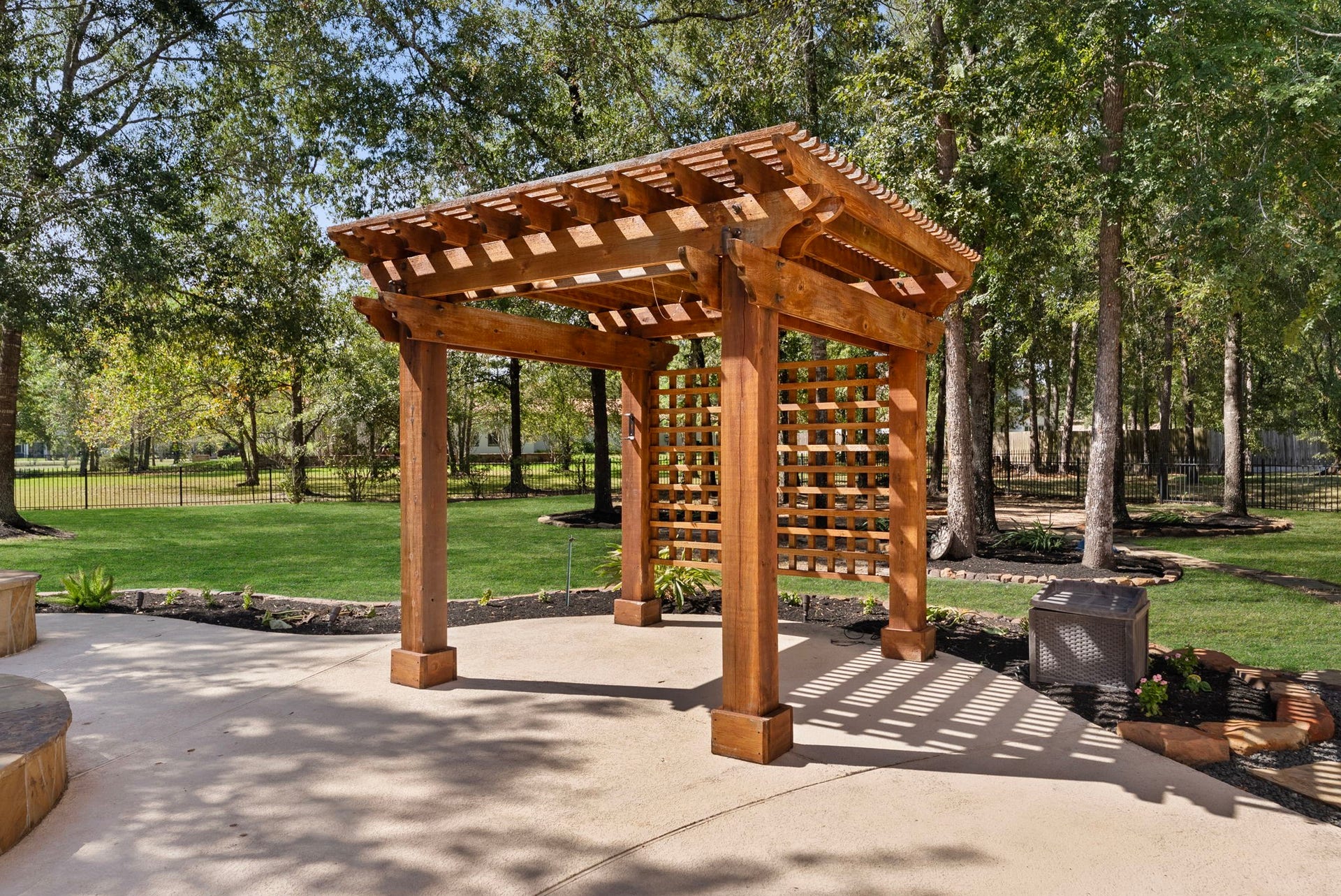 27507 Hunter Creek Court, Spring, TX 77386 Freestanding wood pergola provides an additional outdoor gathering area beside the pool.