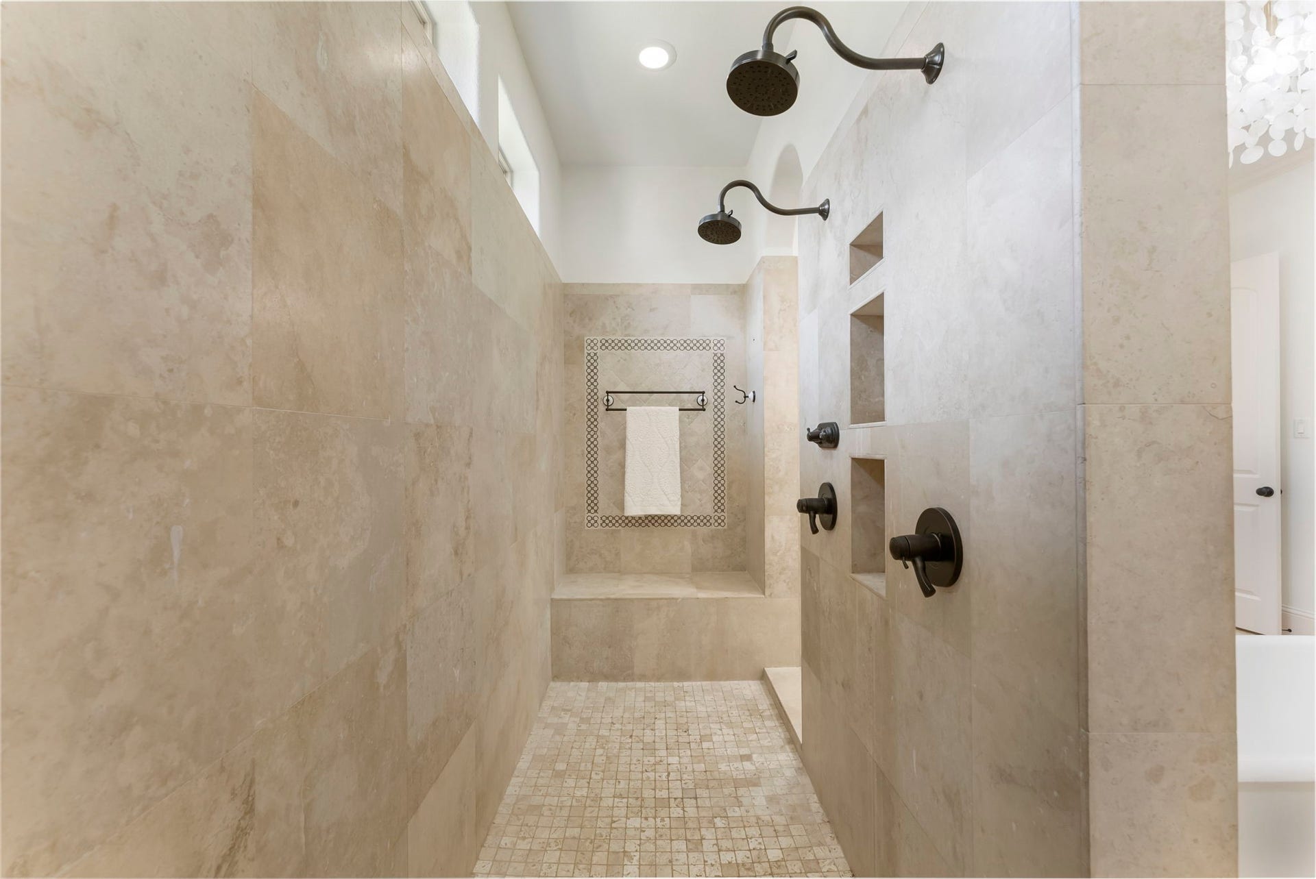 27507 Hunter Creek Court, Spring, TX 77386 Large tiled primary shower with dual showerheads, built-in niches and bench.