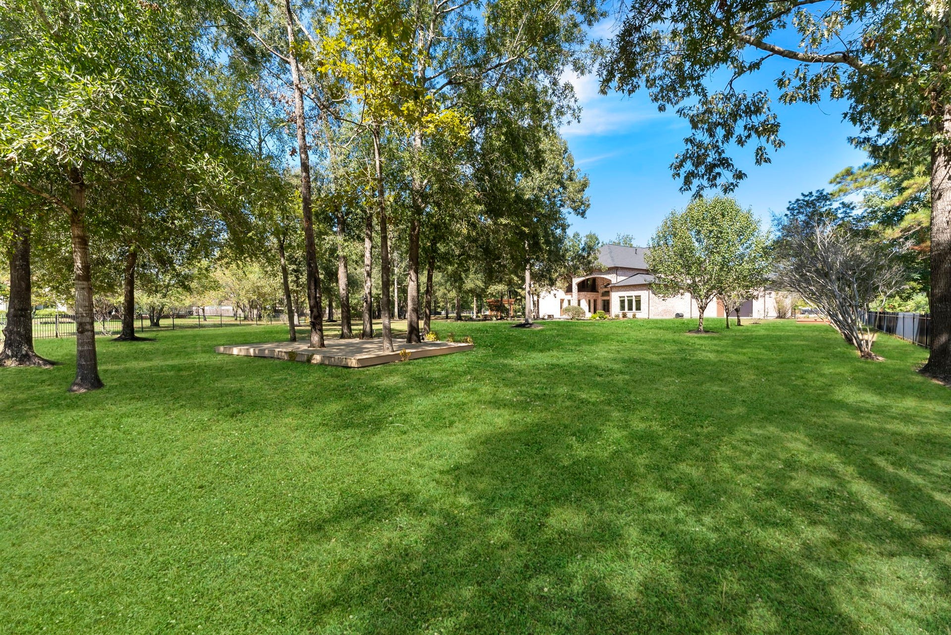 27507 Hunter Creek Court, Spring, TX 77386 Expansive fenced backyard with mature trees and substantial open lawn space.