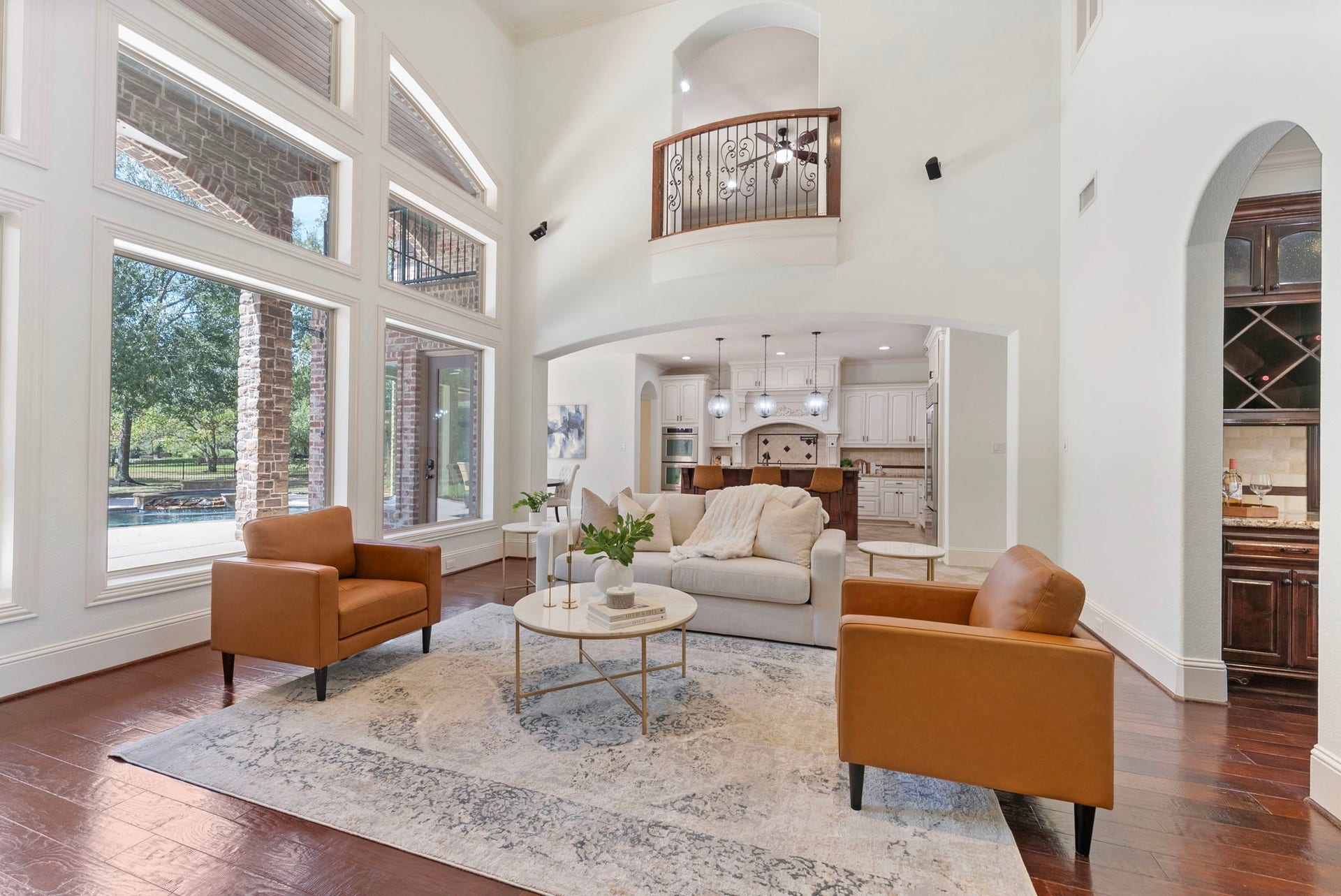 27507 Hunter Creek Court, Spring, TX 77386 Two-story living area featuring soaring ceilings, expansive windows and an open connection to the kitchen.