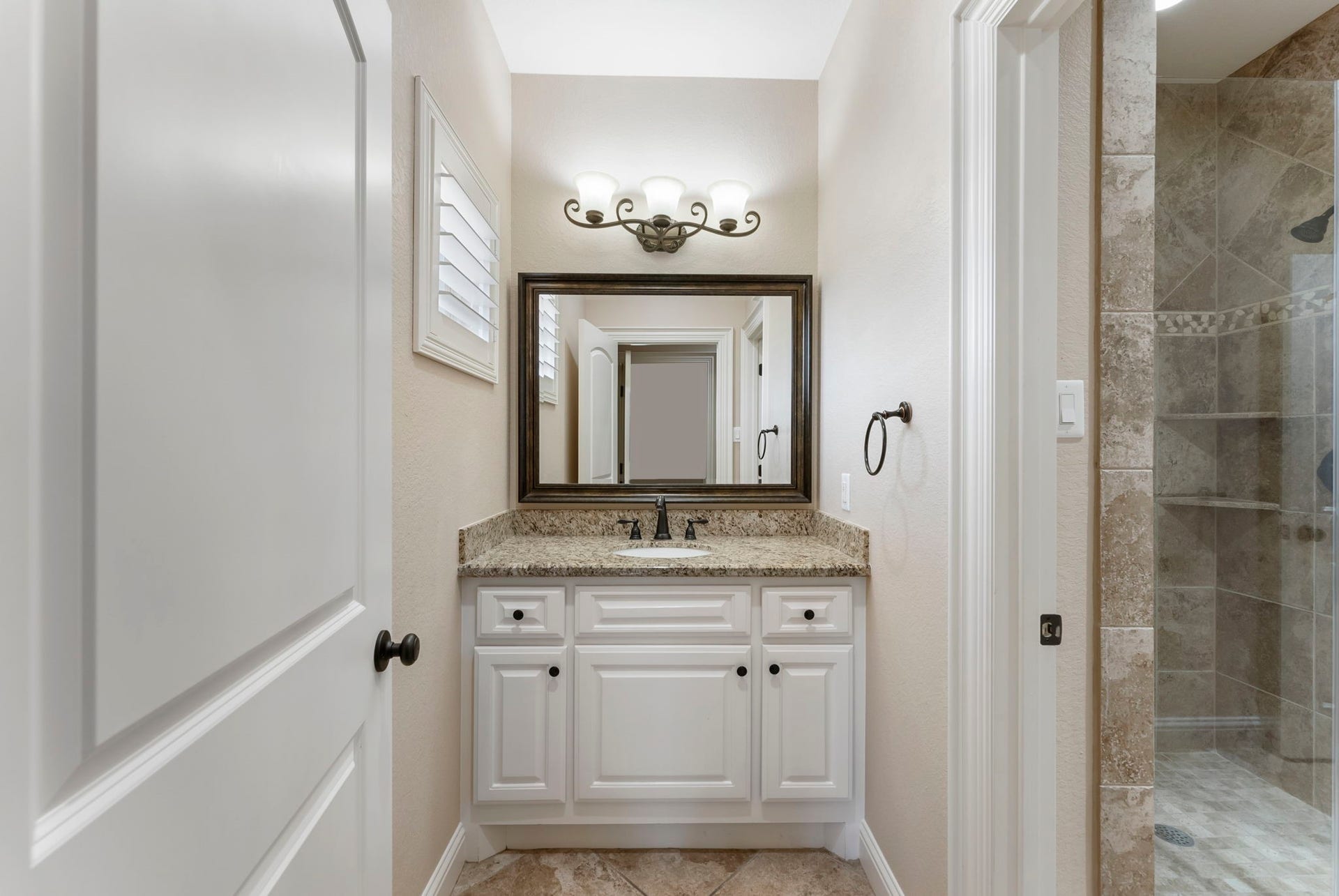 27507 Hunter Creek Court, Spring, TX 77386 Secondary bathroom featuring granite vanity and tiled glass-enclosed shower.