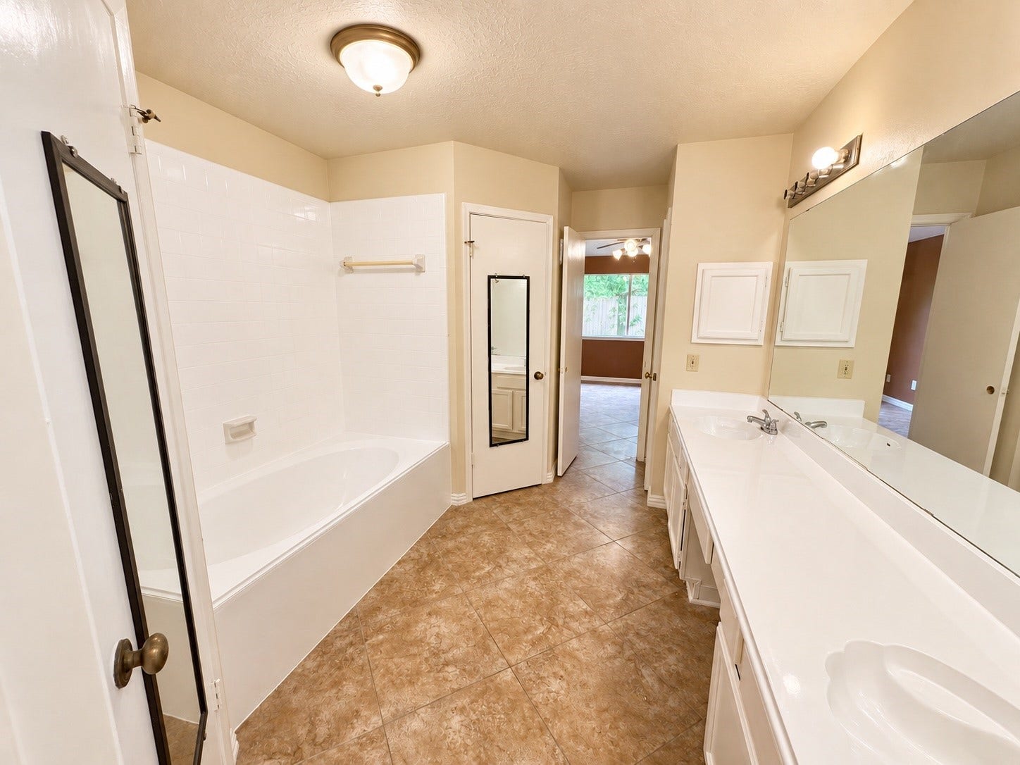 12175 Swords Creek Road, Houston, TX 77067 Primary bathroom with view of tub and two closets