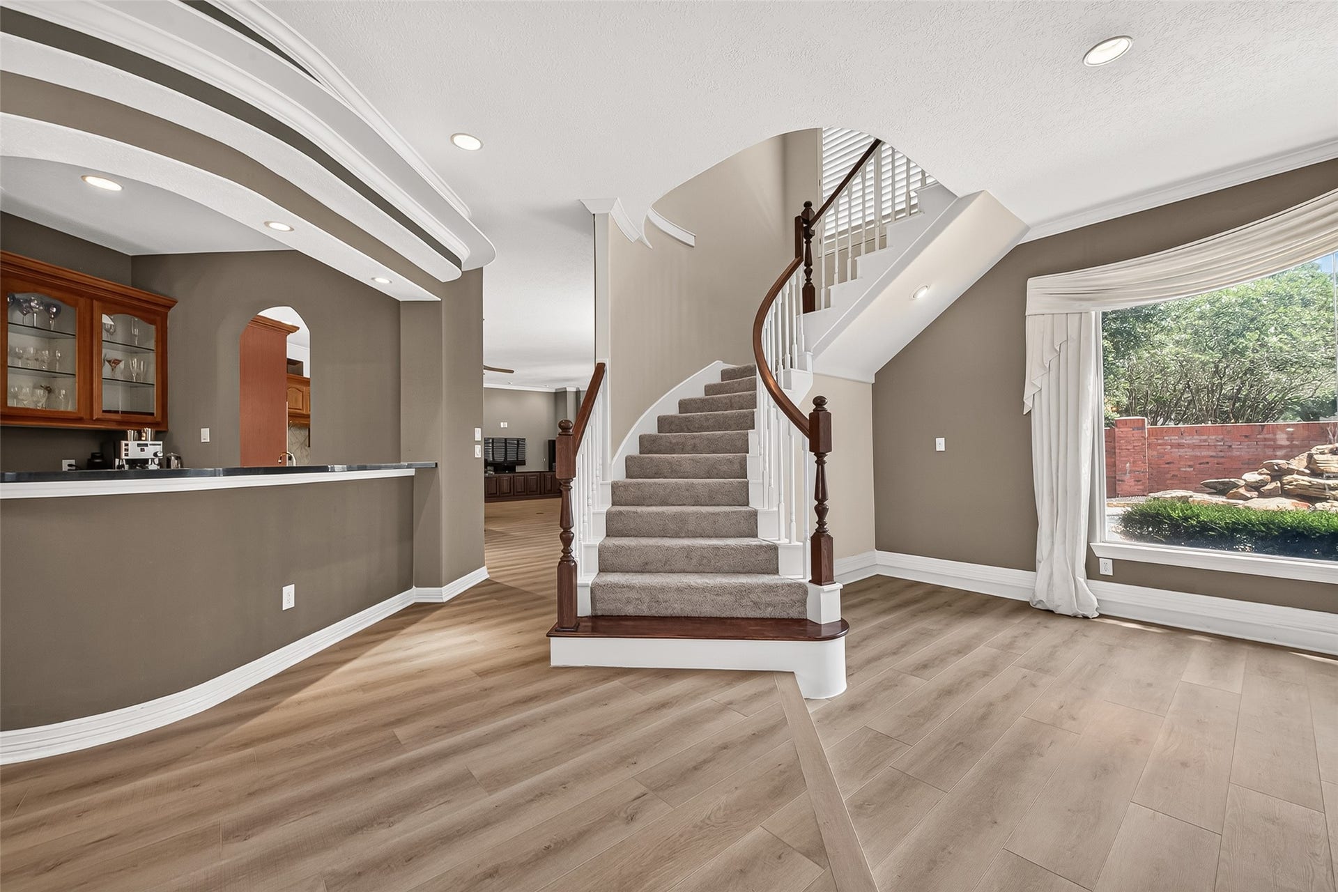 63 Harbor View Drive, Sugar Land, TX 77479 Beautiful LVP flooring throughout, amazing open-concept floor plan, wet bar, and a statement-making grand staircase, the list of things to love about this home goes on and on!
