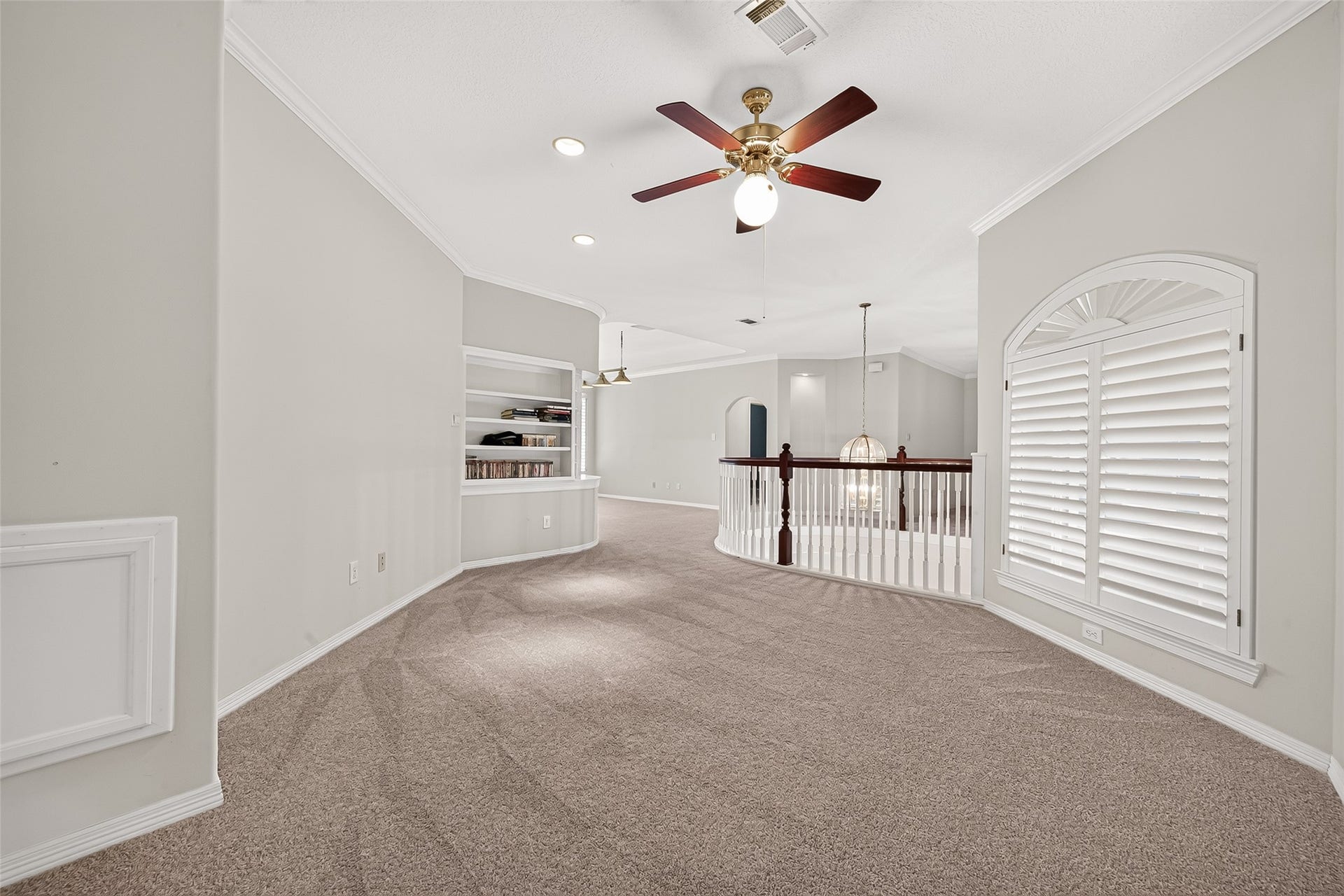 63 Harbor View Drive, Sugar Land, TX 77479 Spacious flex space featuring built-in shelving and elegant railing overlooking the staircase that can be used as an open office or customized to fit your needs