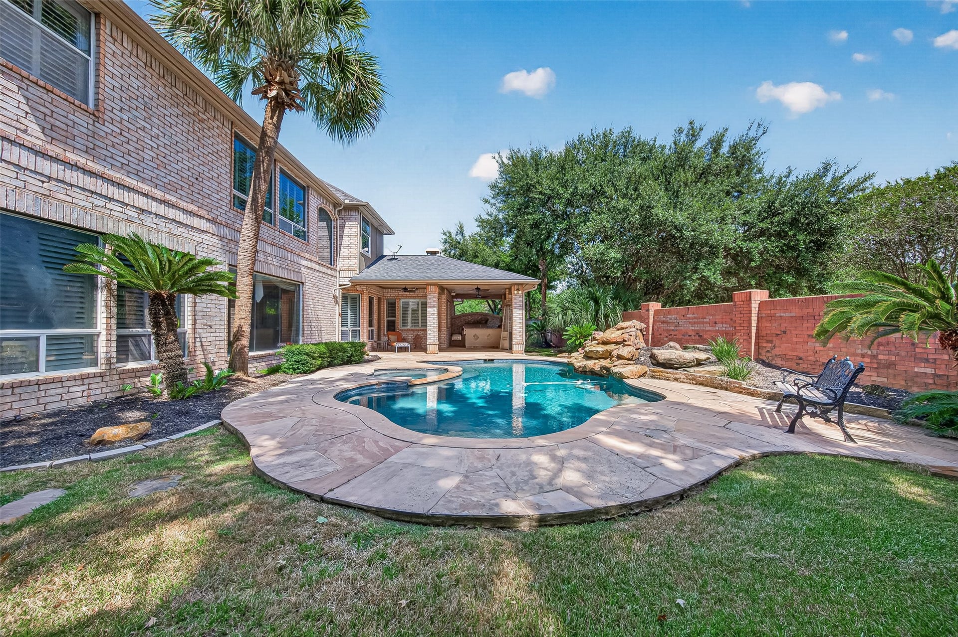63 Harbor View Drive, Sugar Land, TX 77479 Oversized backyard complete with a pool and spa, extended covered patio and amazing outdoor kitchen for you to extend your living outside