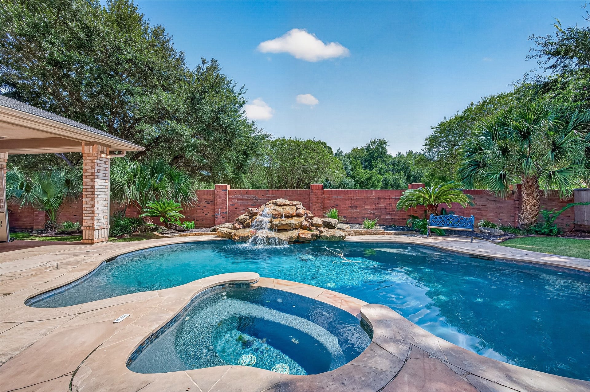 63 Harbor View Drive, Sugar Land, TX 77479 Experience luxury in this backyard oasis featuring a sparkling pool/spa with a waterfall, surrounded by lush landscaping and an extended covered patio