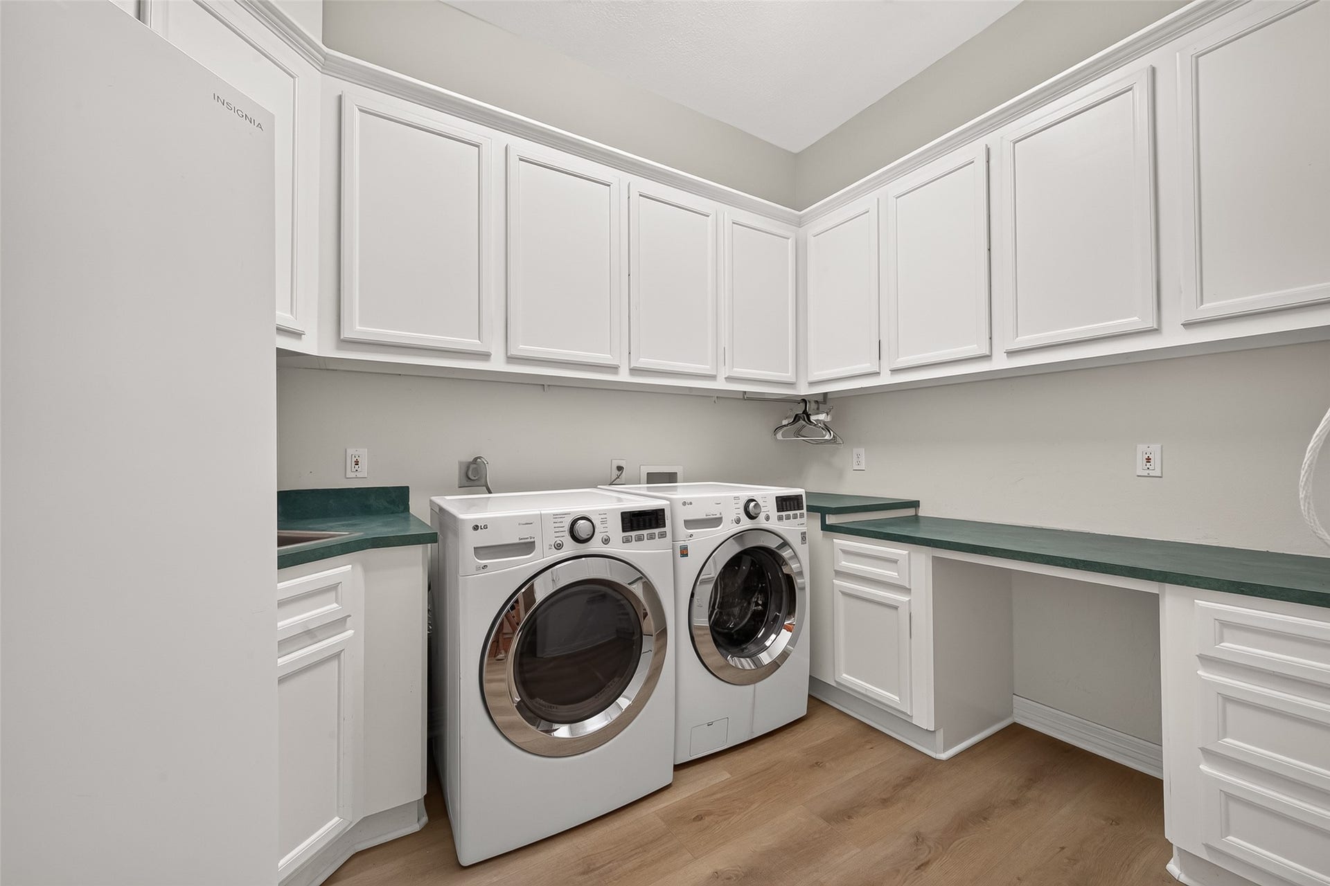 63 Harbor View Drive, Sugar Land, TX 77479 Doing laundry is a breeze in a space like this, complete with a sink, plenty of cabinets for storage, and folding counter.