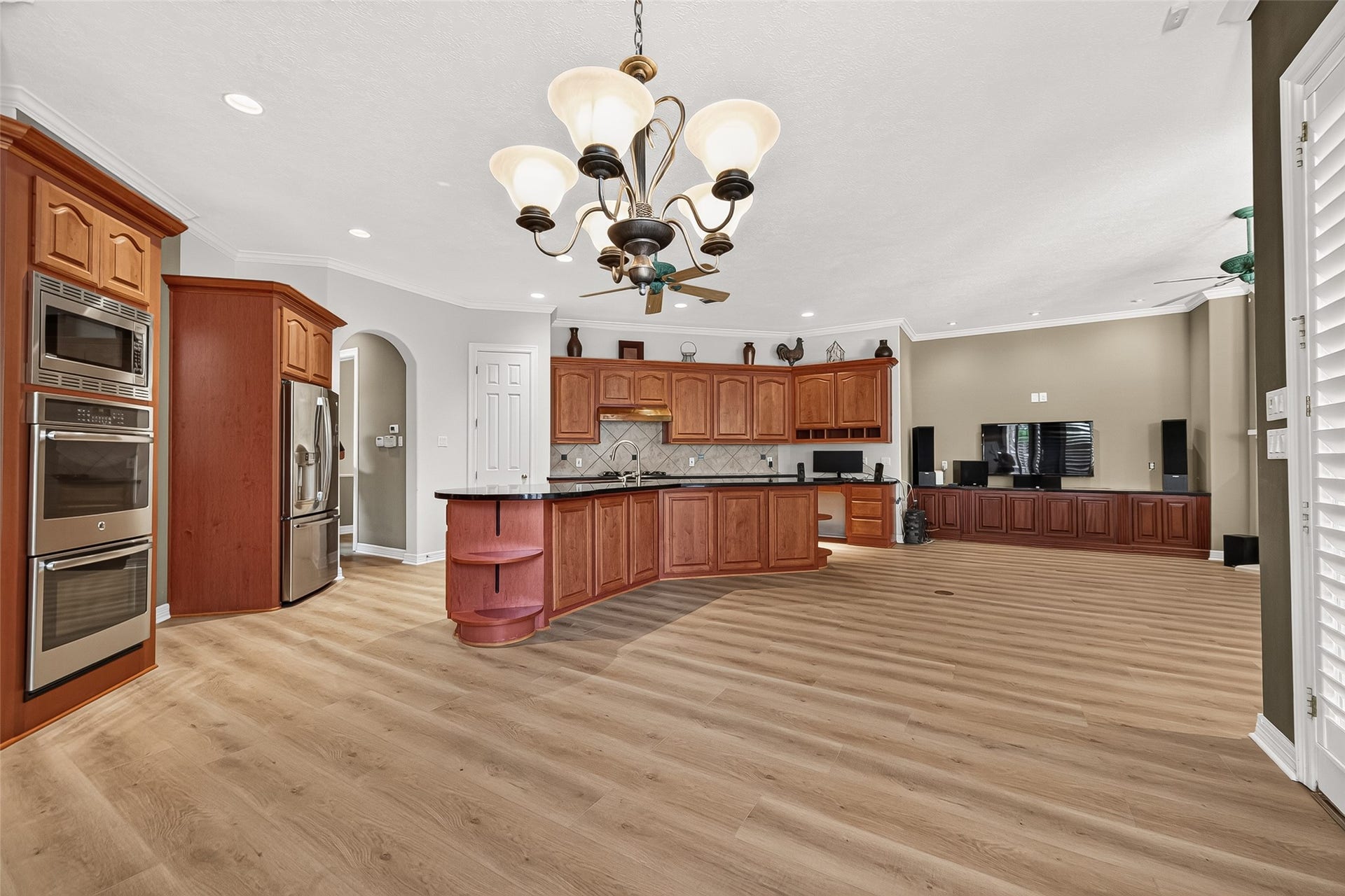 63 Harbor View Drive, Sugar Land, TX 77479 Spacious open-concept kitchen and living area featuring rich wood cabinetry, stainless steel appliances, and plenty of counter and cabinet space.