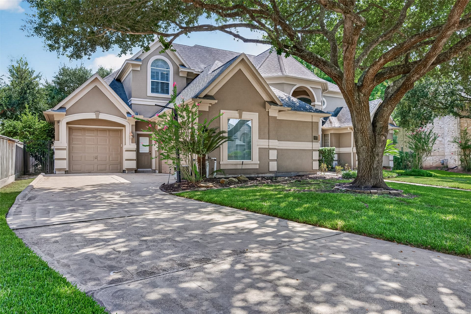 63 Harbor View Drive, Sugar Land, TX 77479 Charming two-story home with a manicured front lawn and mature tree providing shade. 3-car garage with an extended driveway for ample parking.