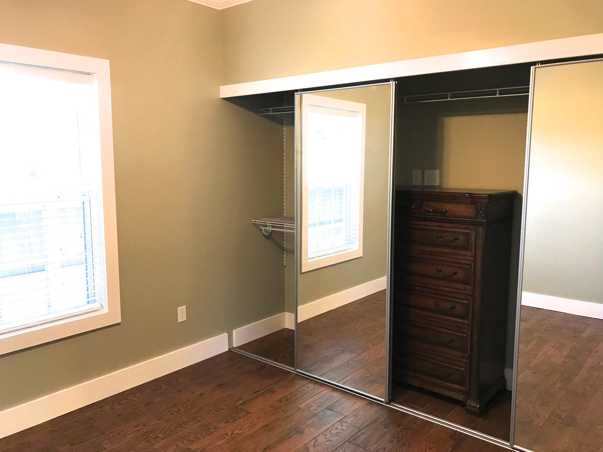 Second bedroom with large closet with sliding mirror doors.  The chest of draws is included with the duplex.