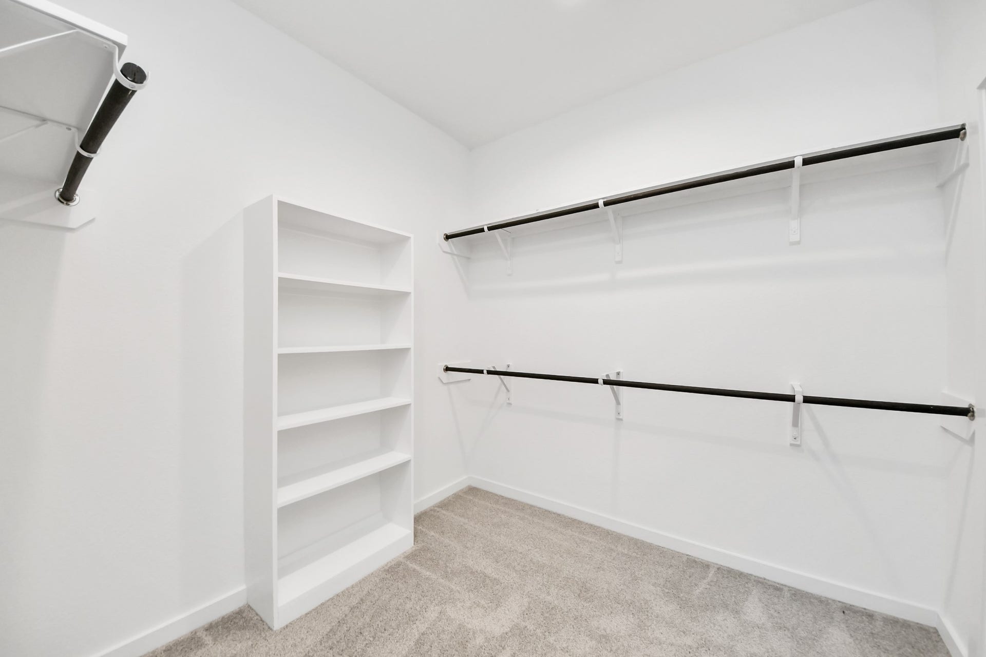 5814 Madison Trail Drive, Richmond, TX 77469 Walk-in closet that epitomizes luxury and practicality. This generously sized space features built-in shelving, offering abundant room for impeccable organization. High ceilings and recessed lighting create a bright and welcoming ambiance. Sample photo of completed home with similar floor plan. Actual colors and selections may vary.