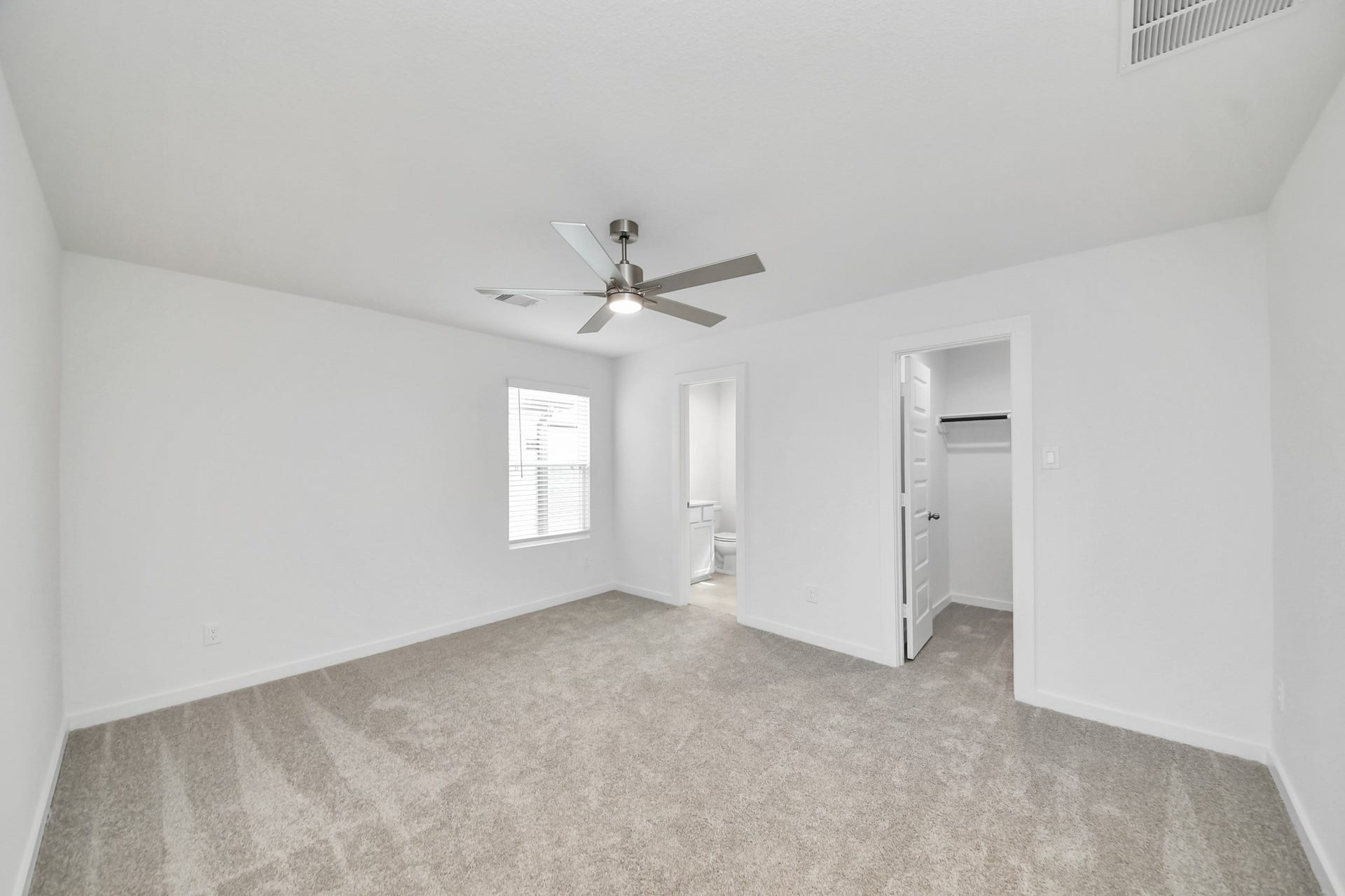 5814 Madison Trail Drive, Richmond, TX 77469 Secondary bedroom features plush carpeting, large windows that let in plenty of natural light, bright paint, and spacious closets. Sample photo of completed home with similar floor plan. Actual colors and selections may vary.