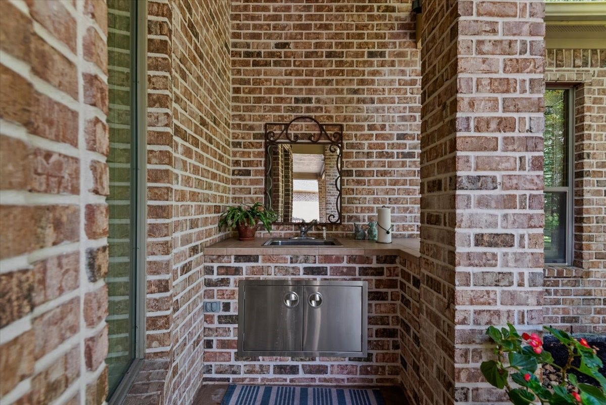 5530 Regal Landing Drive, Kingwood, TX 77345 There is a sink tucked away at the back wall of the patio- perfect for cleaning up after grilling or gardening.