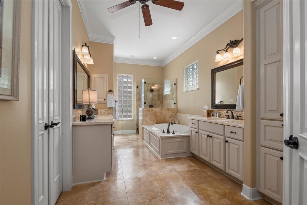 5530 Regal Landing Drive, Kingwood, TX 77345 The primary bathroom boasts dual vanities, a garden tub and seperate shower.