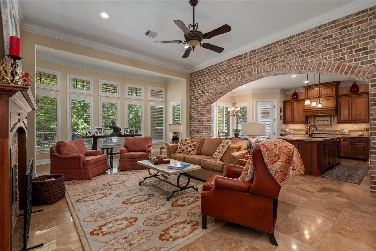 5530 Regal Landing Drive, Kingwood, TX 77345 The main living room shares the beautiful brick archway and view of the lush landscape in the backyard.