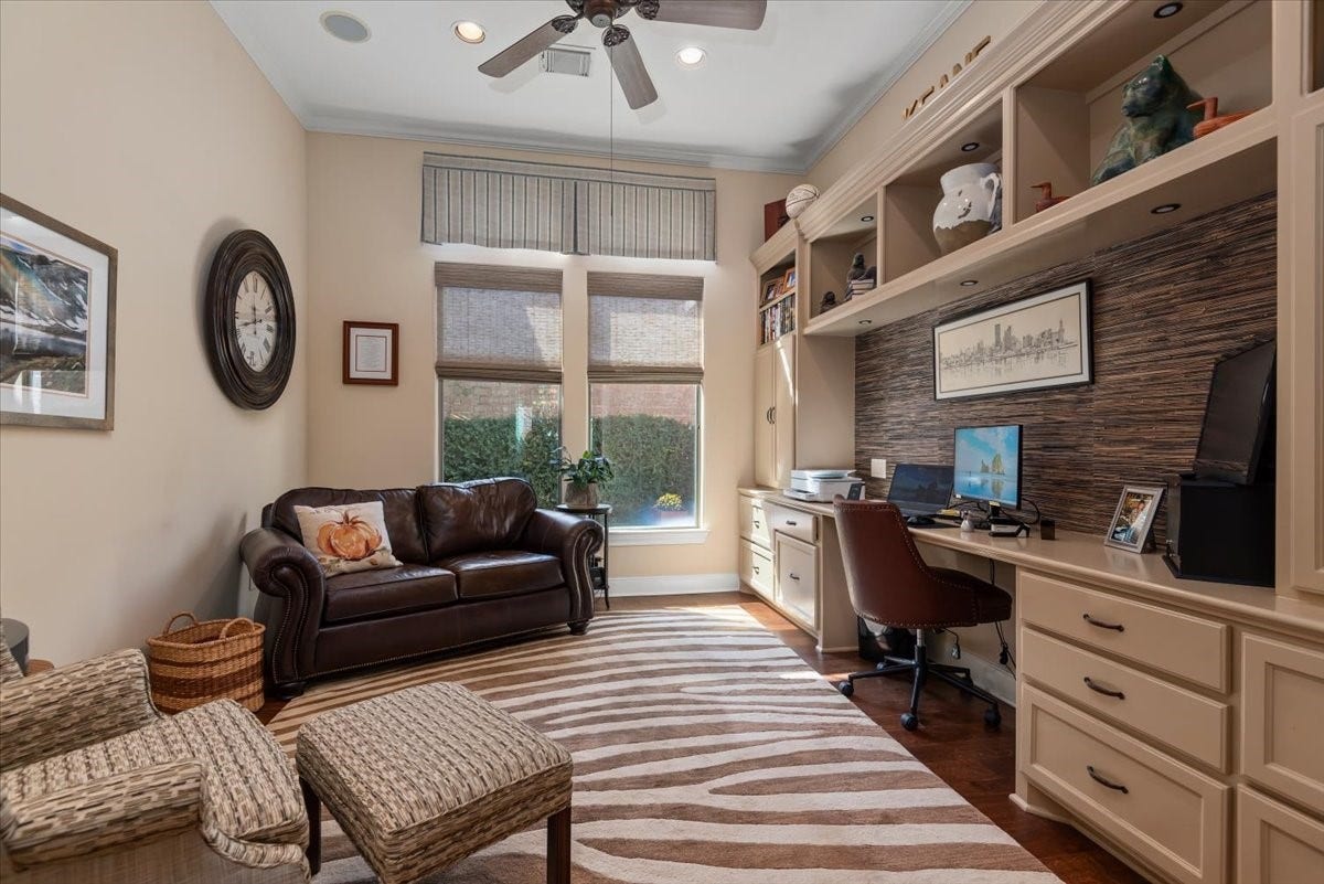 5530 Regal Landing Drive, Kingwood, TX 77345 A wall of built-ins make this office extremely functional. Window shades and custom draperies frame the view to private garden courtyard.