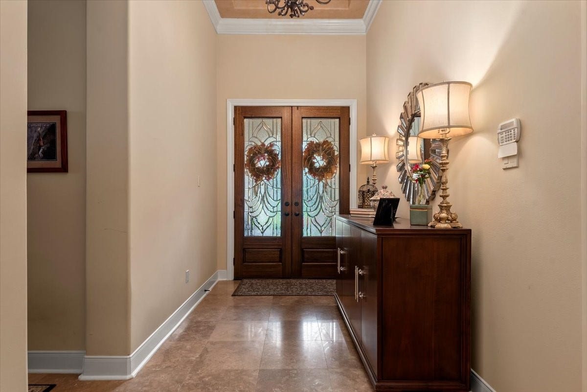 5530 Regal Landing Drive, Kingwood, TX 77345 Travertine floors and tall ceilings extend into the main living areas.