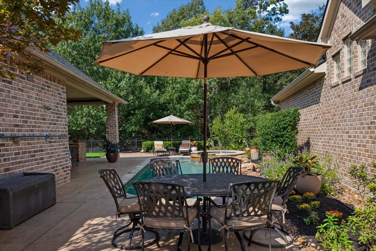 5530 Regal Landing Drive, Kingwood, TX 77345 Second outdoor patio area at the east end of the pool. On the wall (at left) there is an outdoor shower.