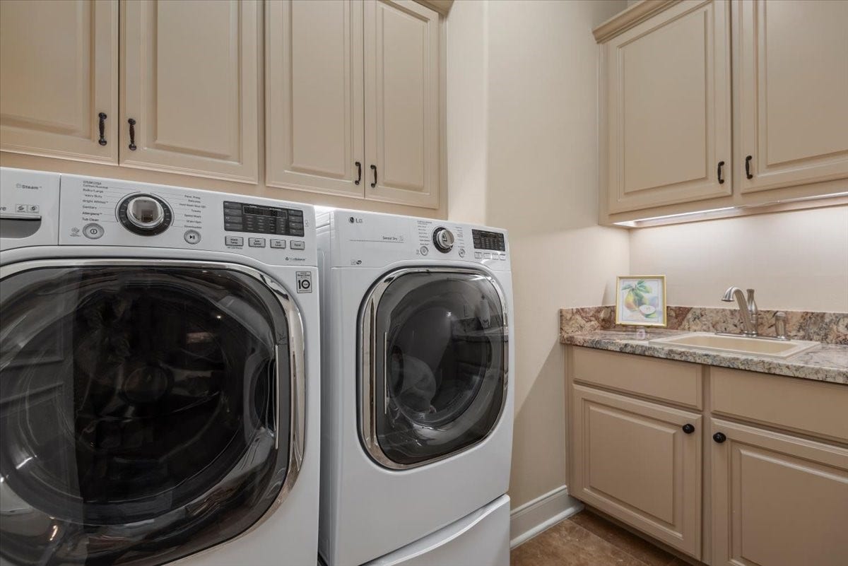 5530 Regal Landing Drive, Kingwood, TX 77345 The utility room features tons of cabinets and a handy sink!